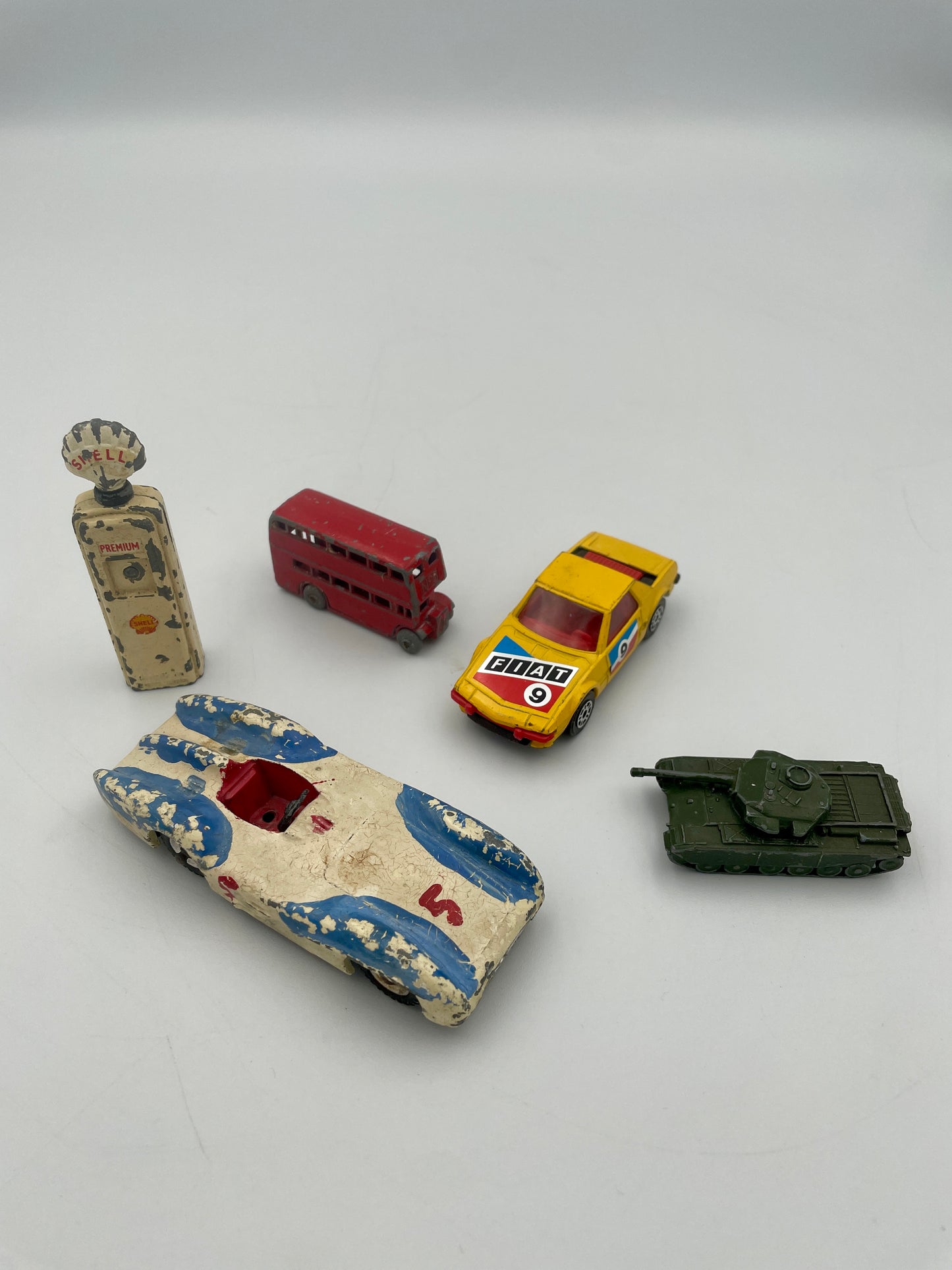 Collection of vintage toy vehicles on a plain background