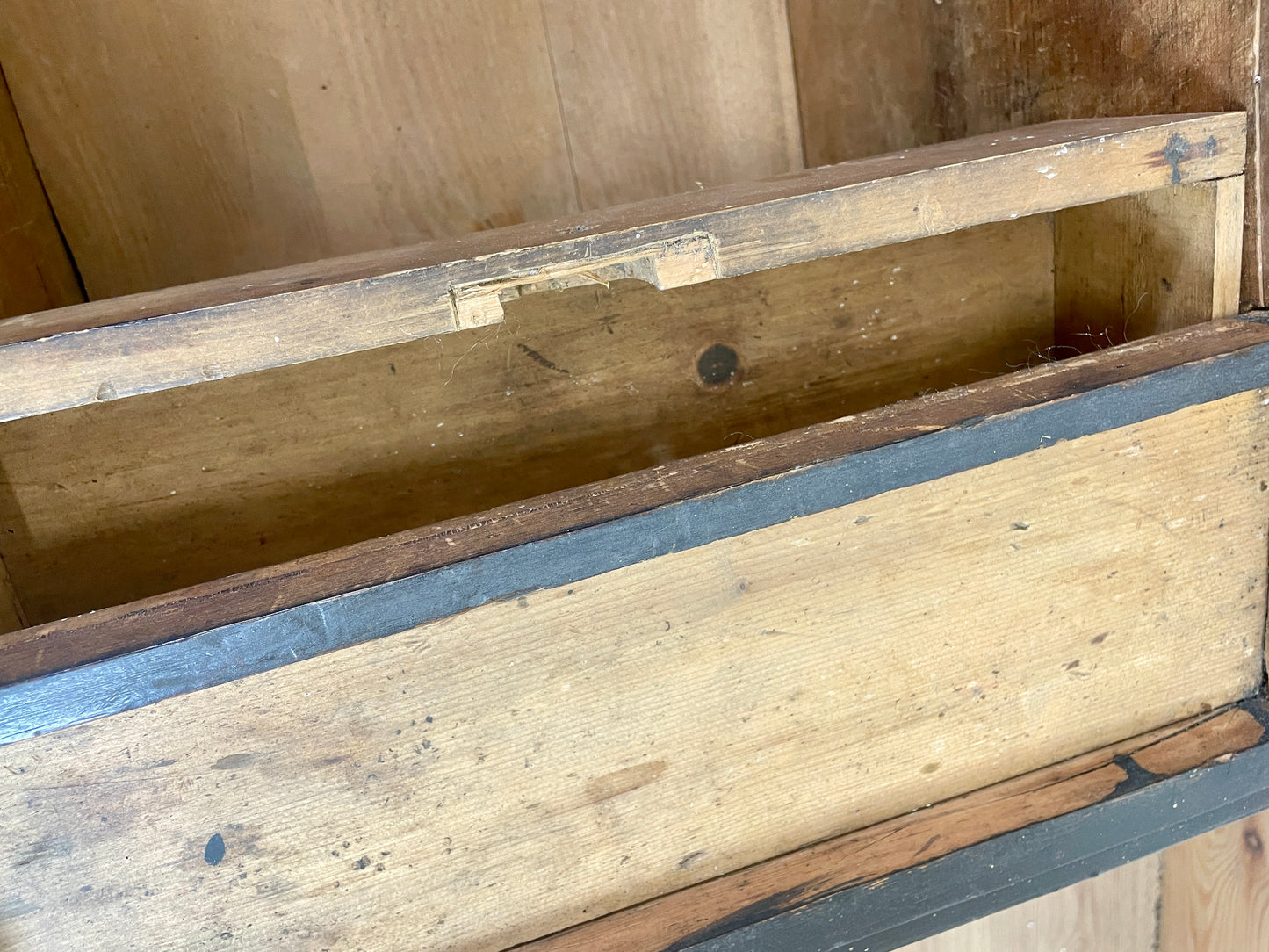 Wooden box with a blue interior on a wooden floor