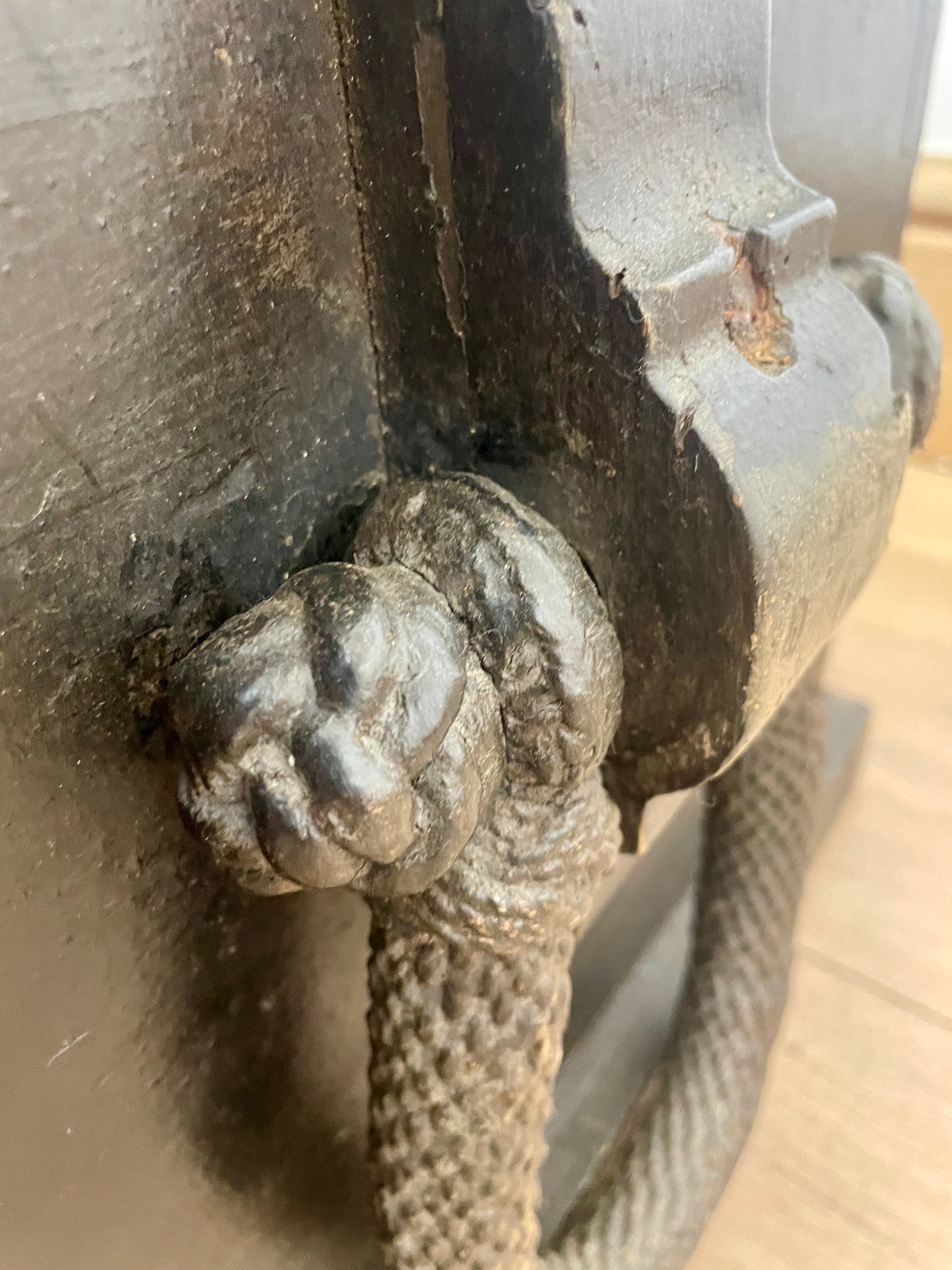Close-up of a metal handle with a textured grip on a mechanical or industrial object.