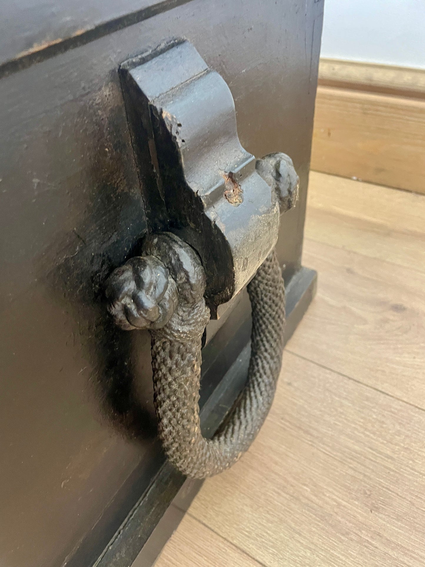 Metal door handle on a wooden surface