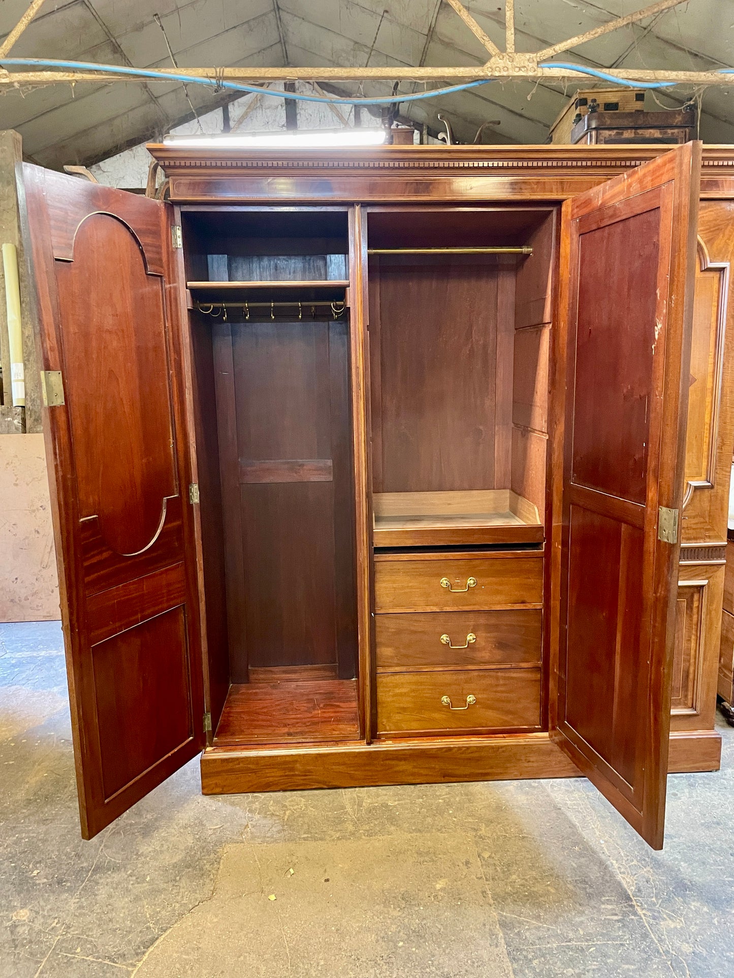 Wooden wardrobe with open doors in a storage or warehouse setting