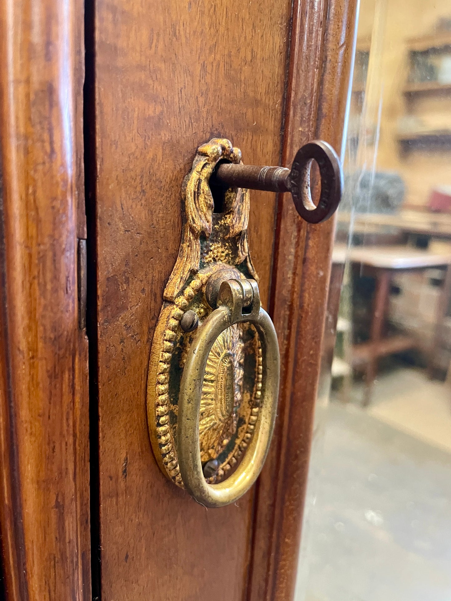 Close-up of a wooden door with a brass doorknob and keyhole.