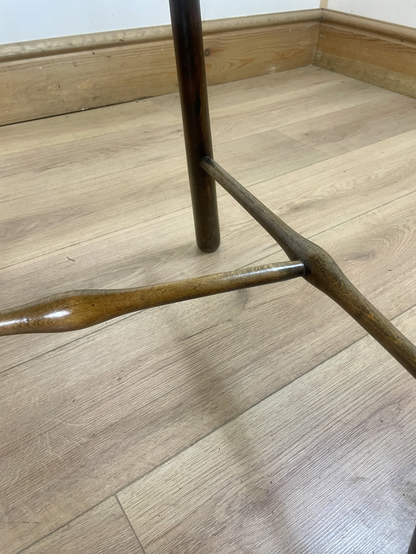 Brown wooden chair leg on a wooden floor