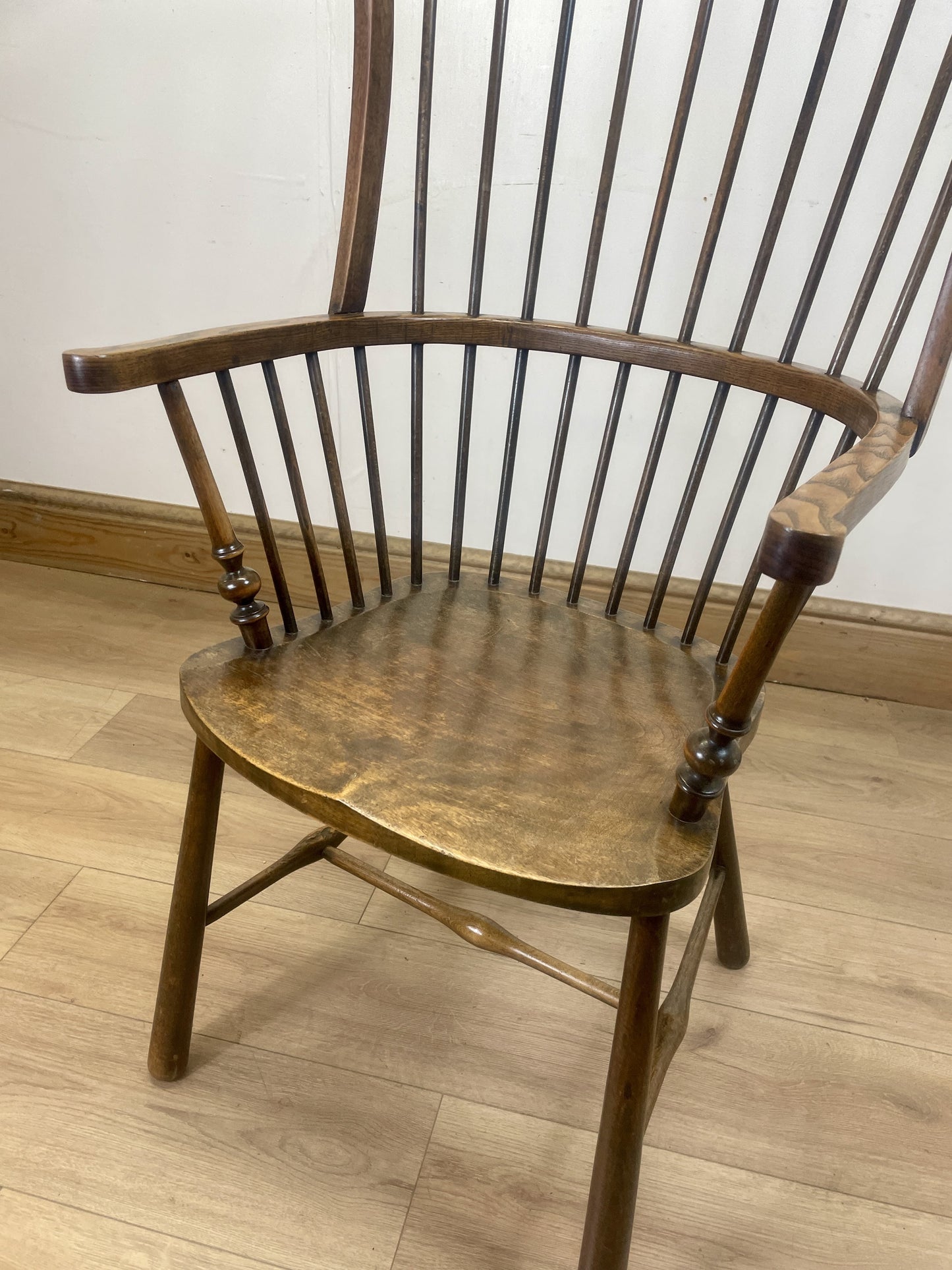 Wooden chair with slatted backrest on a wooden floor