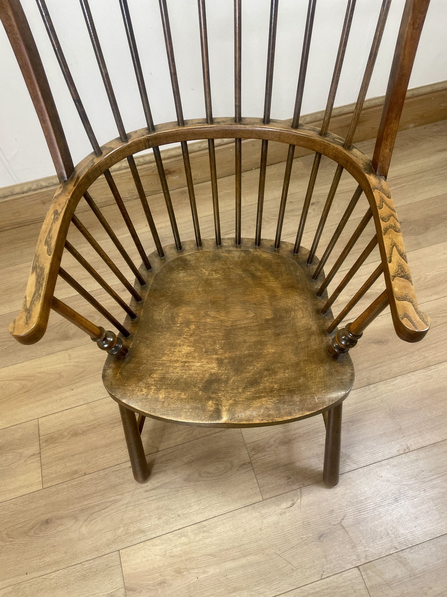 Wooden armchair with spindle back on a wooden floor