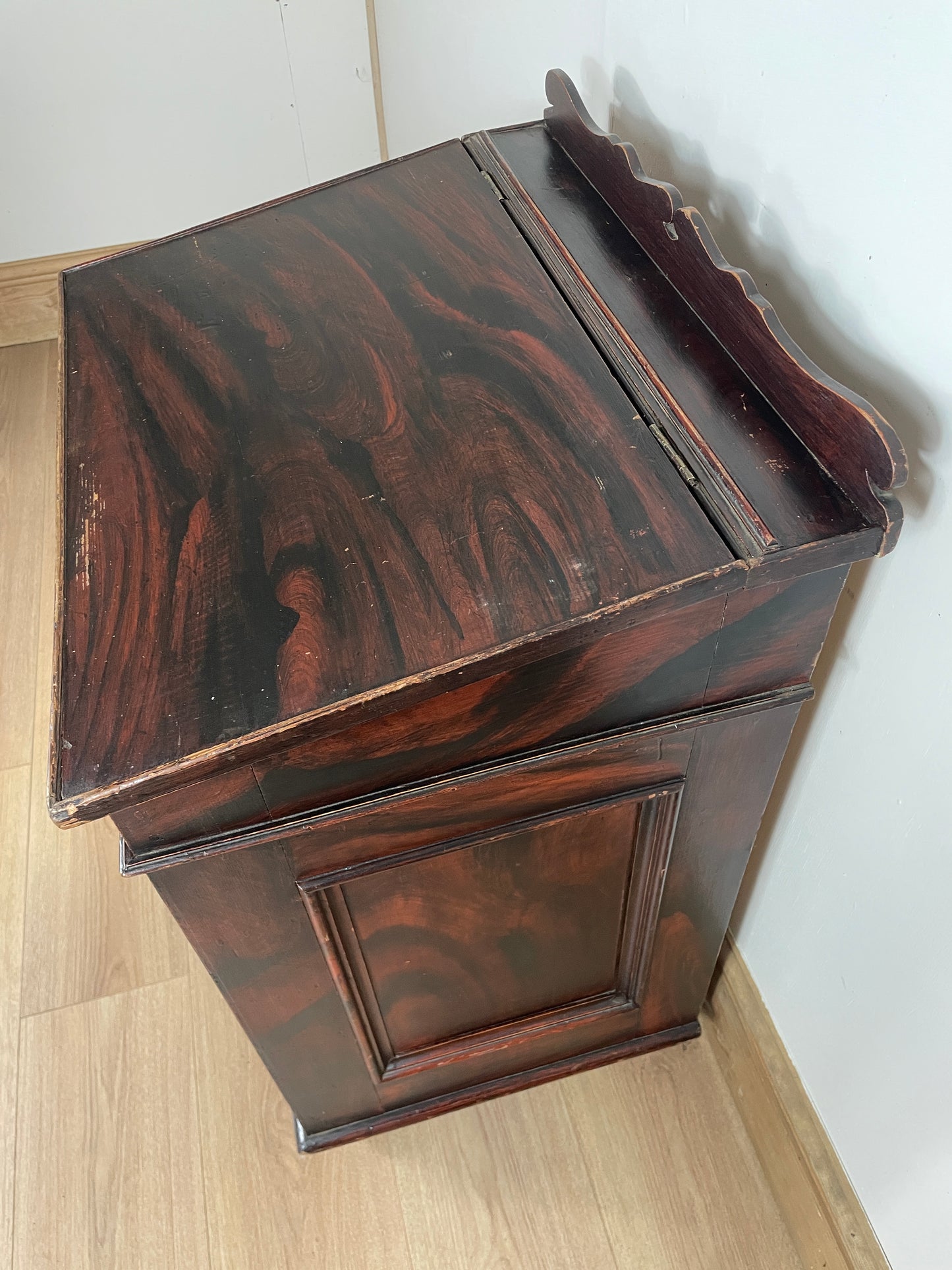 Wooden box with a glossy finish on a light wooden surface