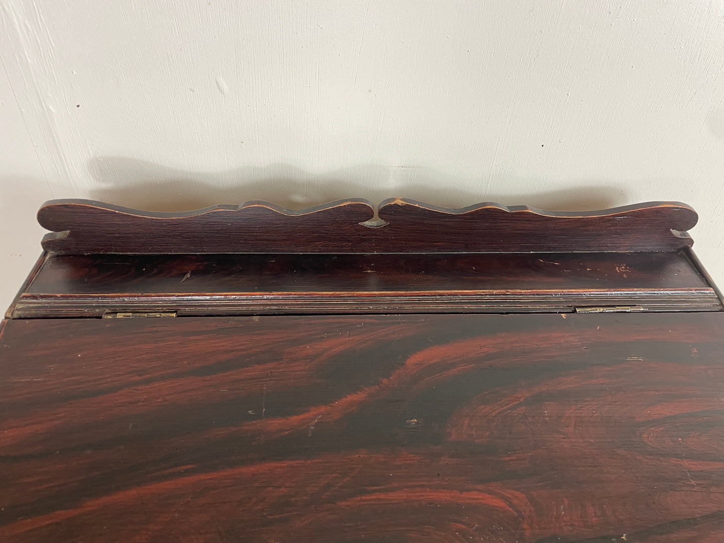 Wooden shelf with decorative backrest on a white background