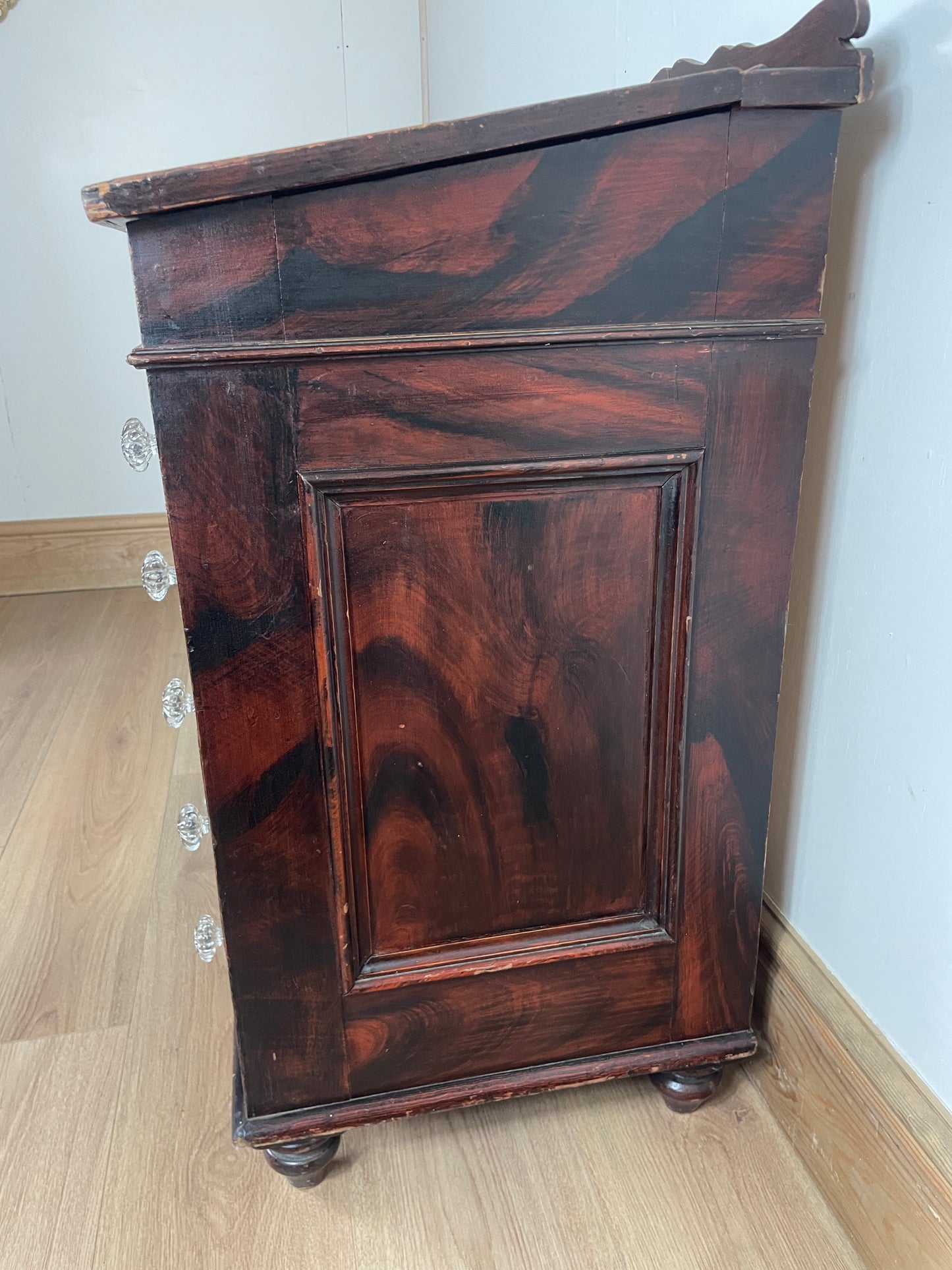 Dark wooden cabinet on a light wooden floor