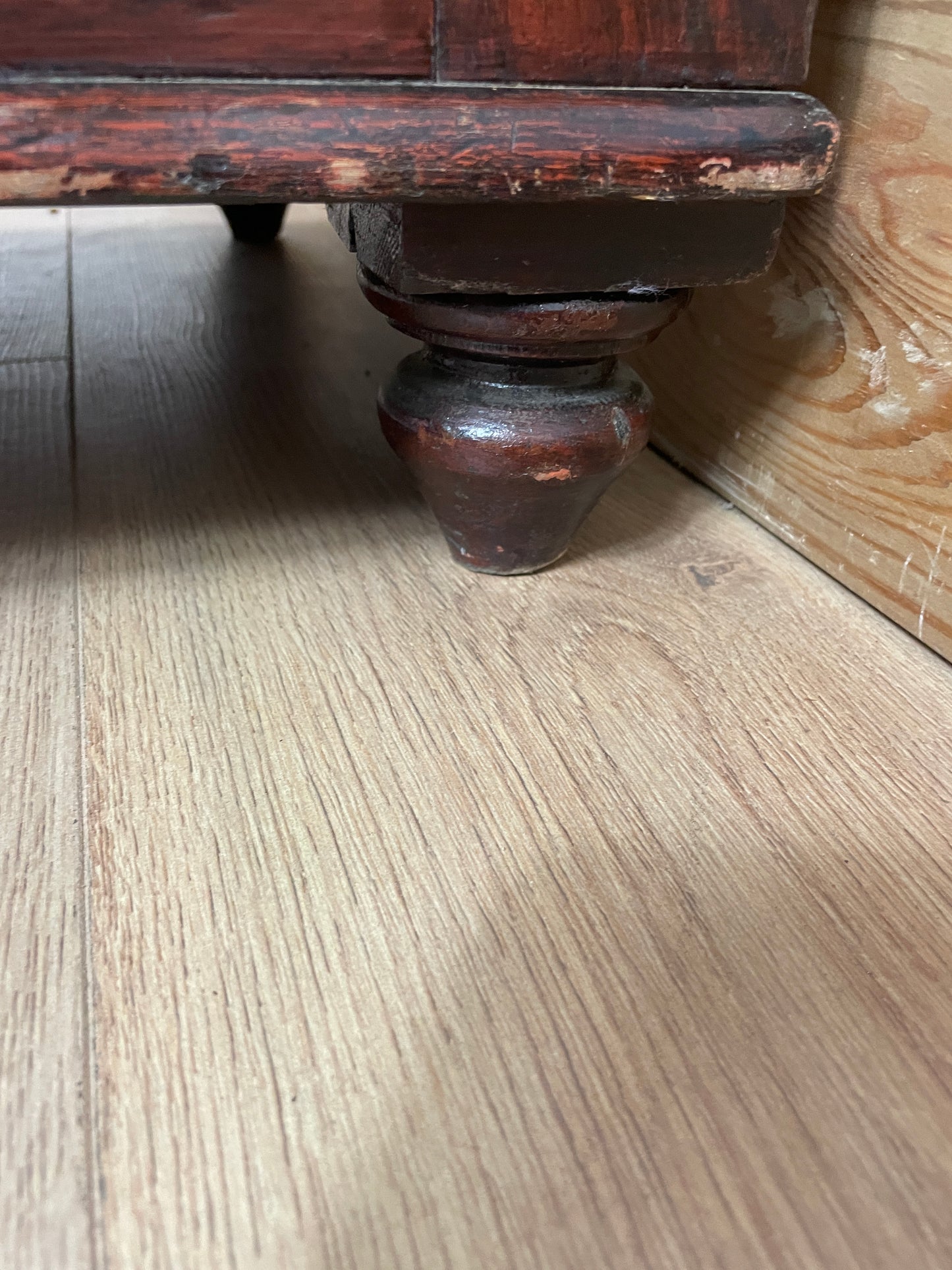 Wooden door stopper on a wooden floor