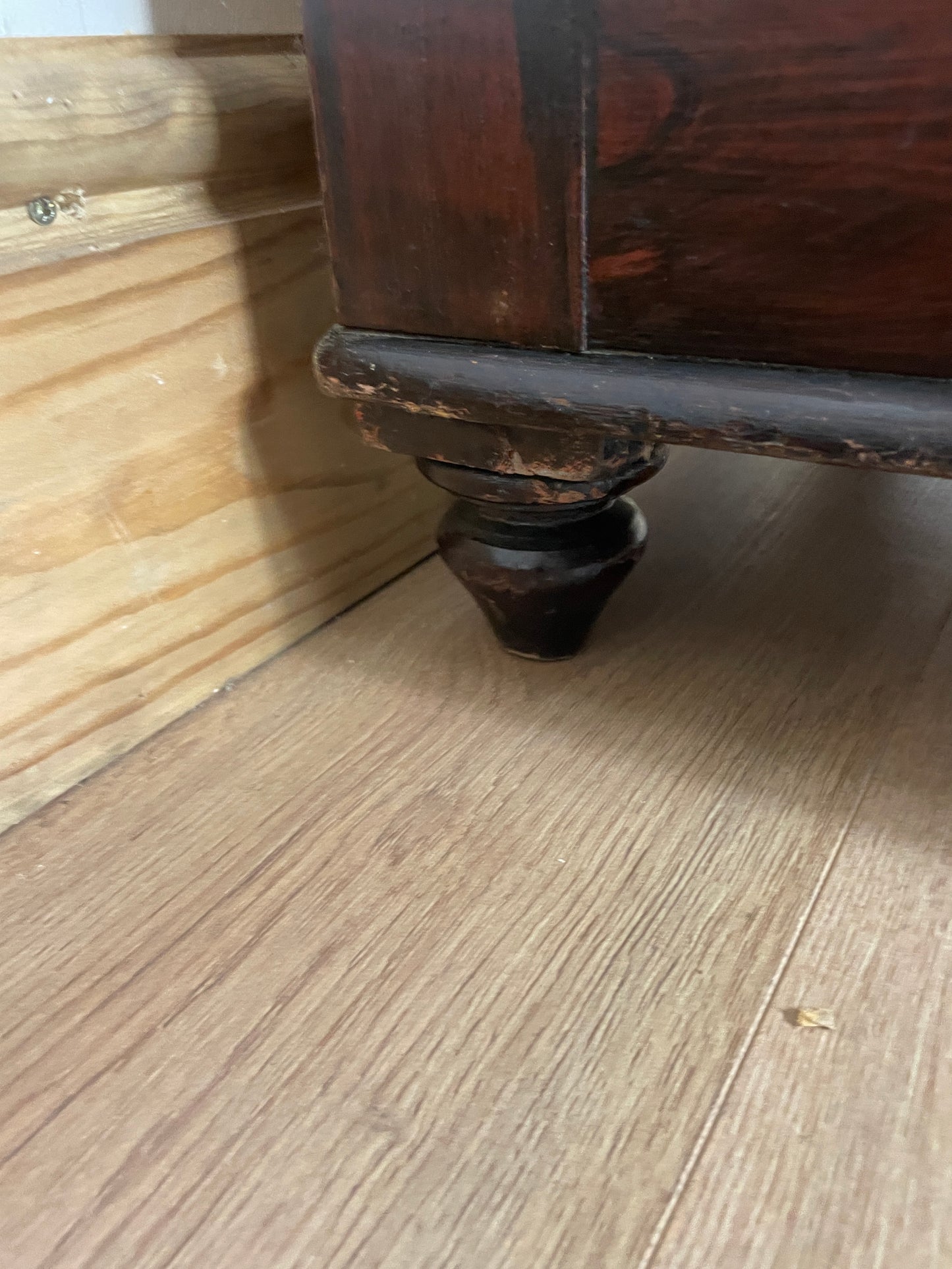 Close-up of a wooden drawer with a metal handle on a wooden surface.