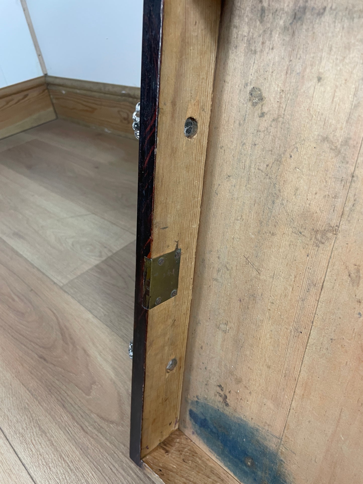 Wooden shelf with metal bracket on a wooden floor