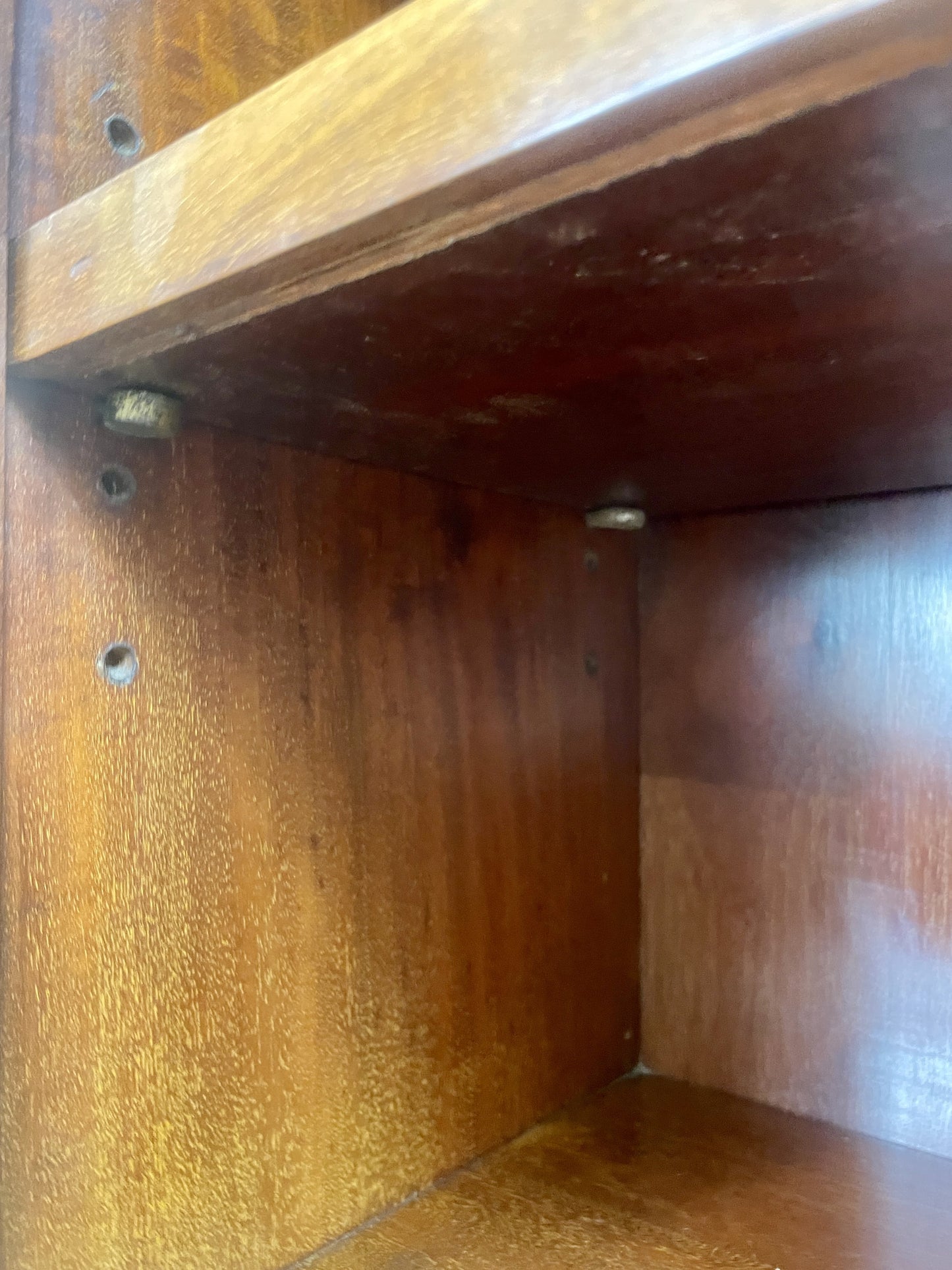 Close-up of a wooden shelf with a focus on the corner.