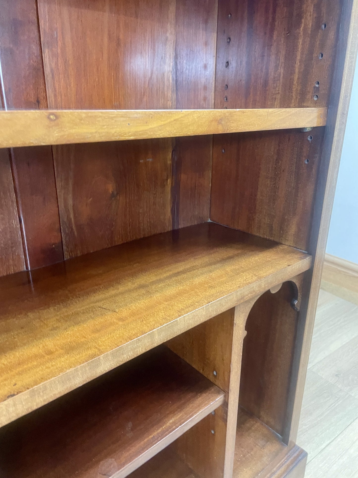 Wooden shelf with a curved design in a room setting