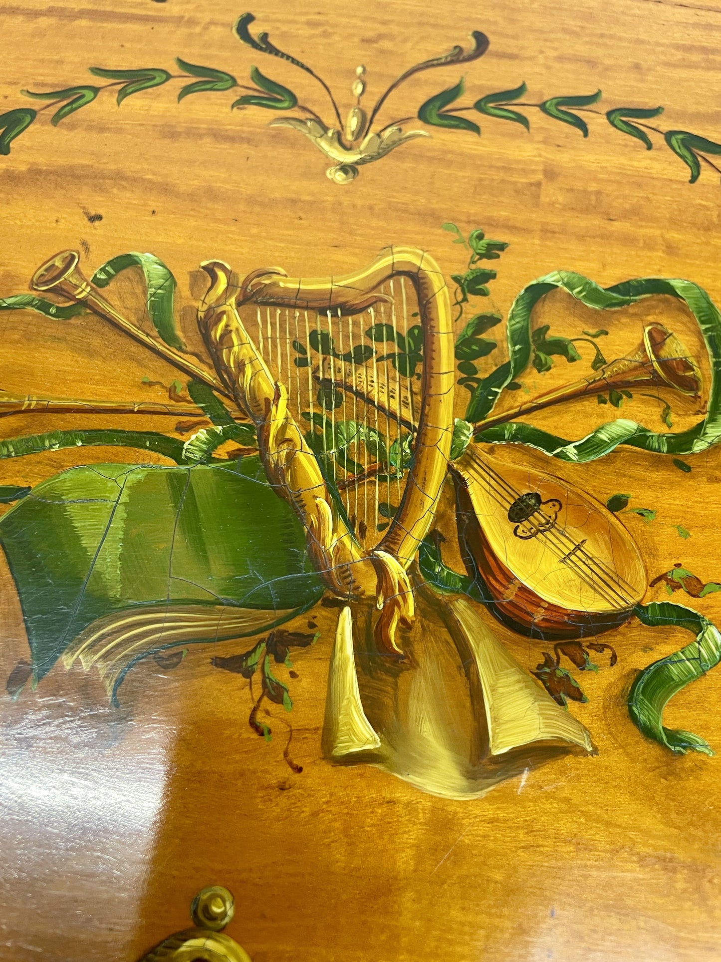 Decorative design on a wooden surface with musical instruments and foliage
