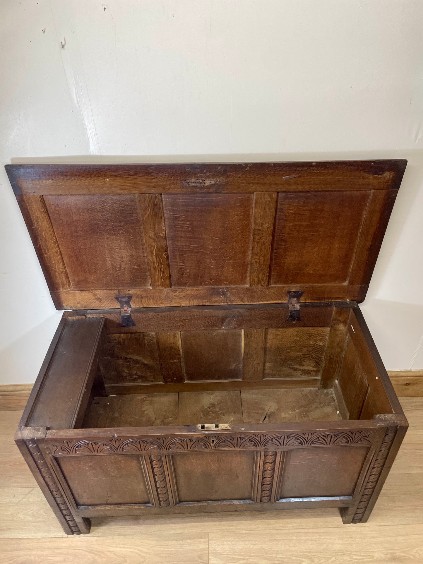 Wooden chest with intricate carvings on a plain background