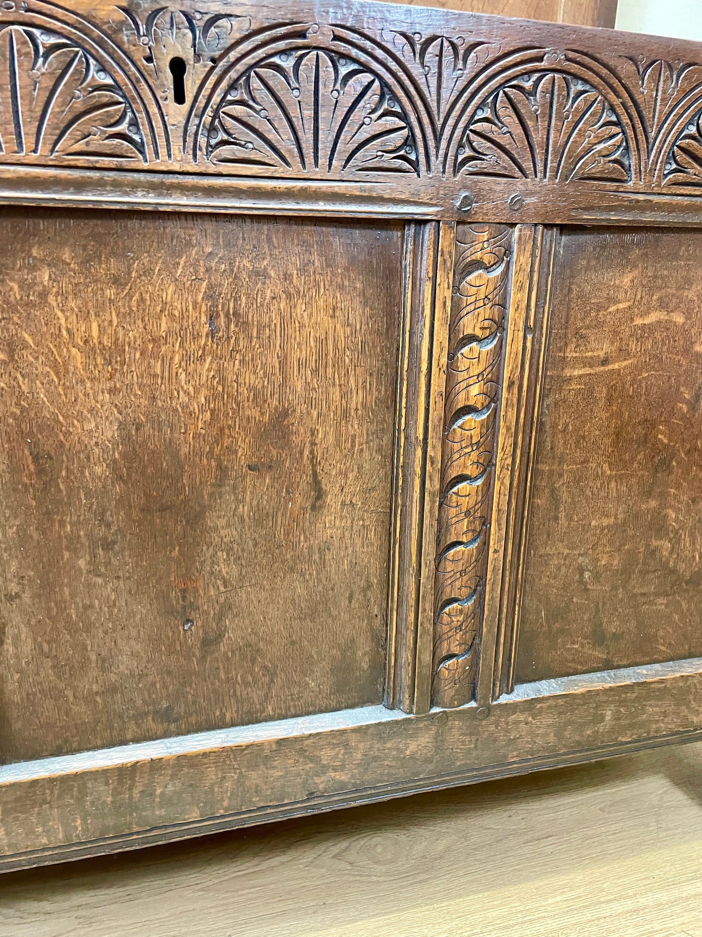 Carved wooden panel with intricate patterns on a wooden surface