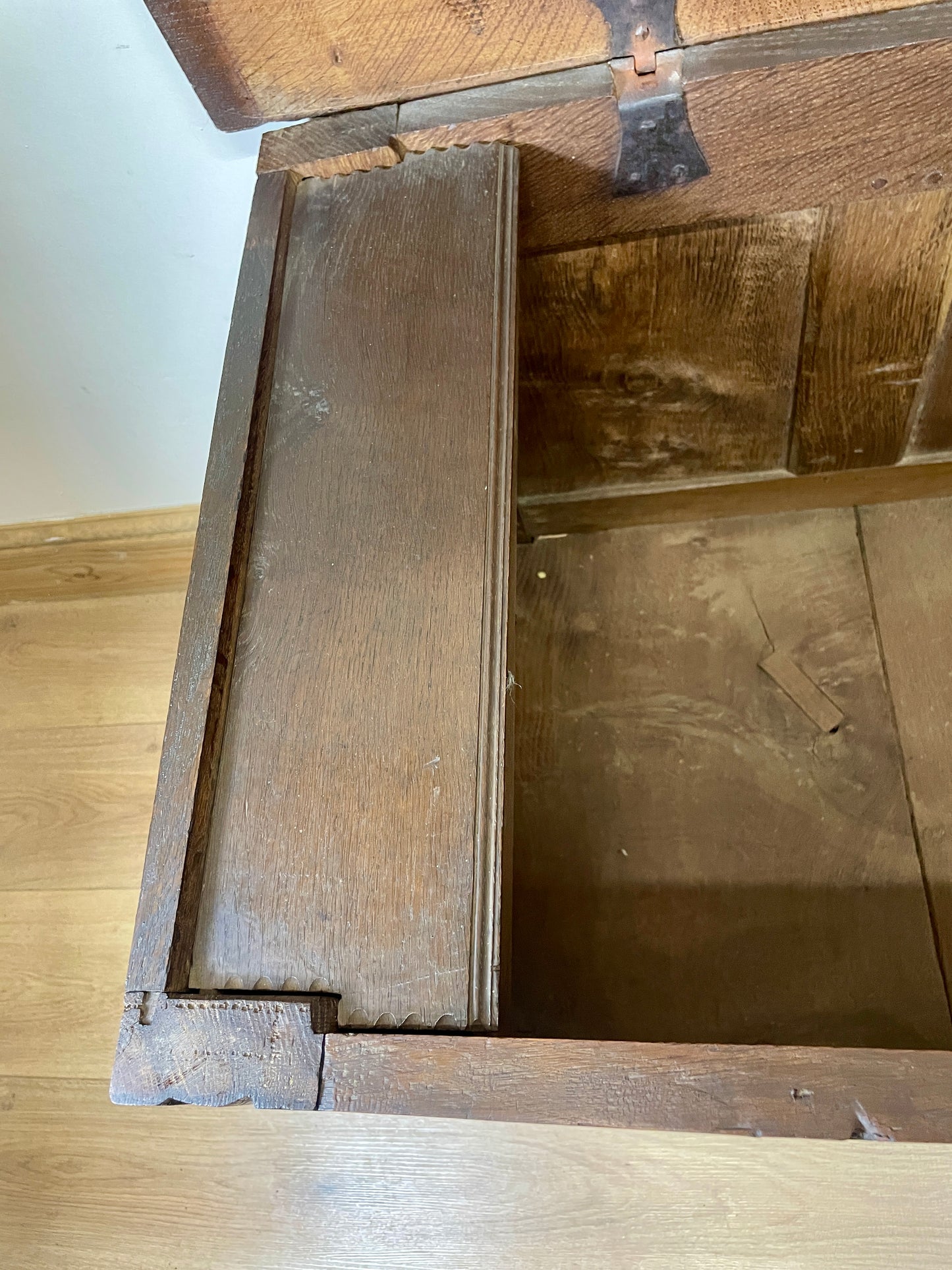 Wooden box with a lid on a wooden surface