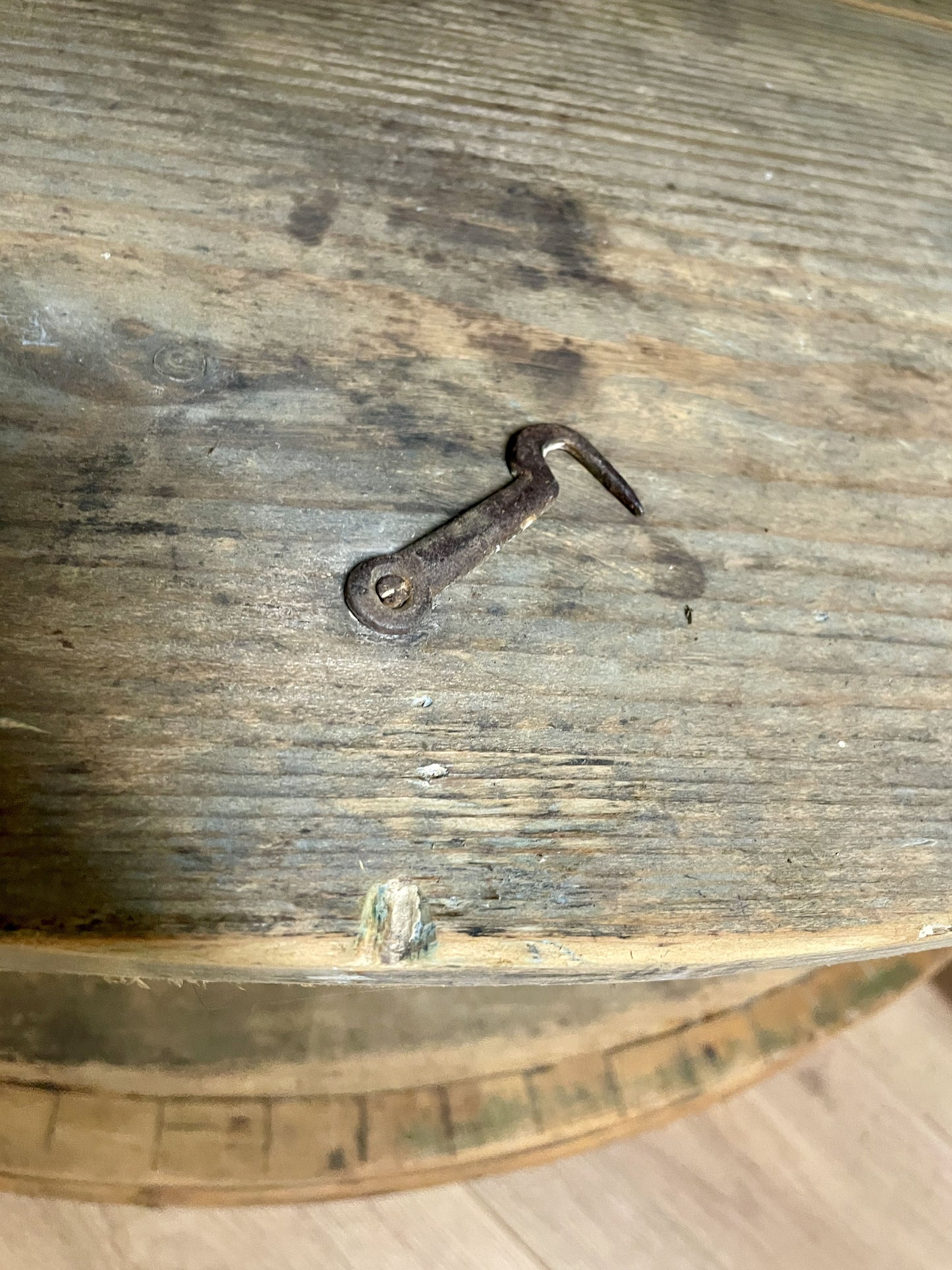 Rustic wooden surface with a metal hook embedded in it