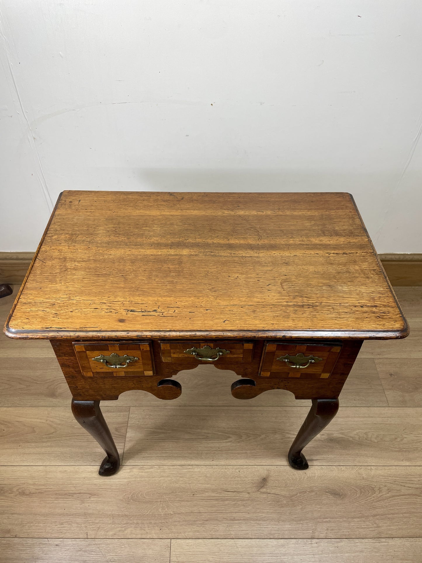 Wooden table with a white wall and wooden floor background