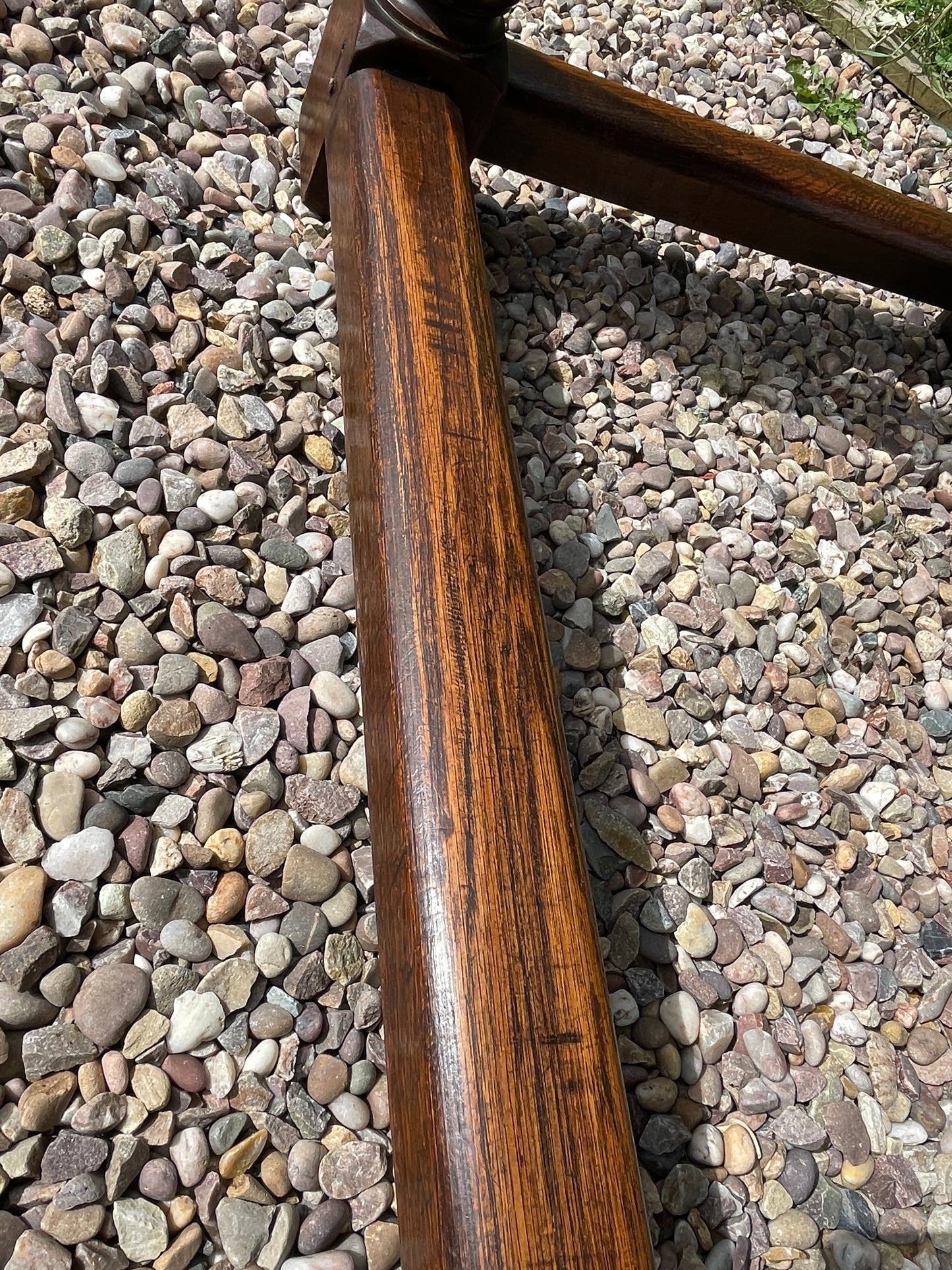 Wooden rod on a bed of small stones