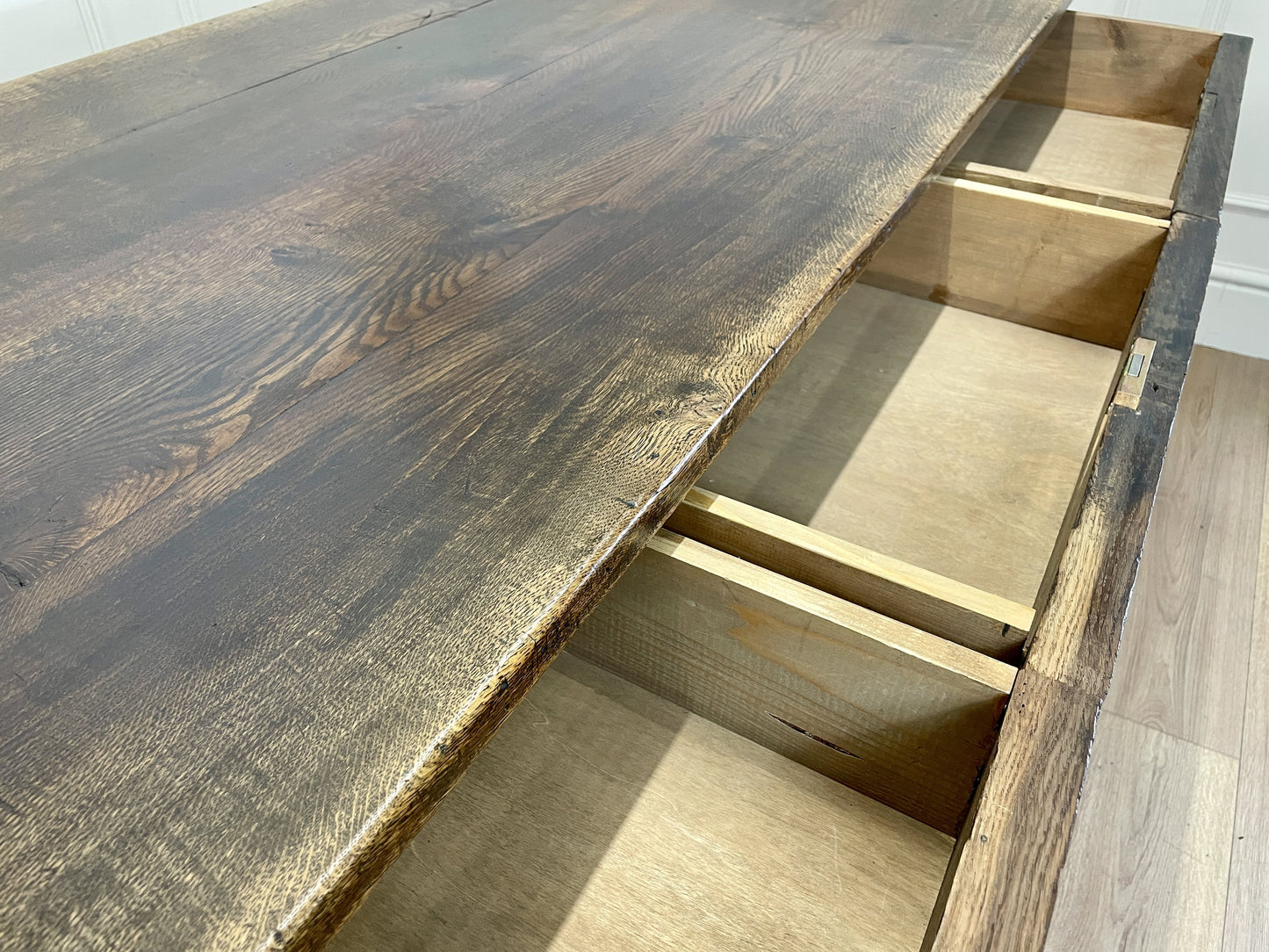 Wooden desk with a dark finish and visible grain patterns.
