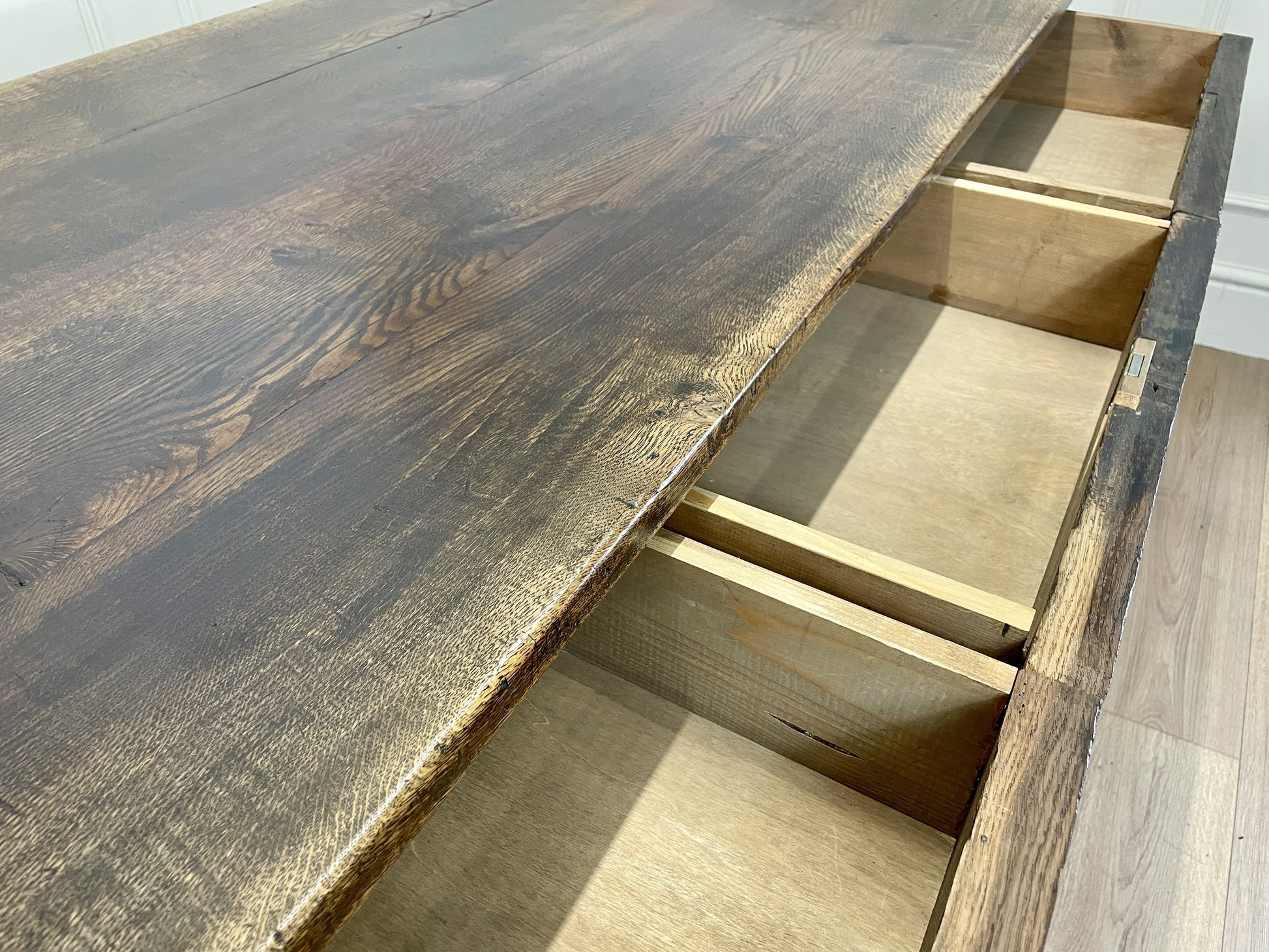 Wooden desk with a dark finish and visible grain patterns.