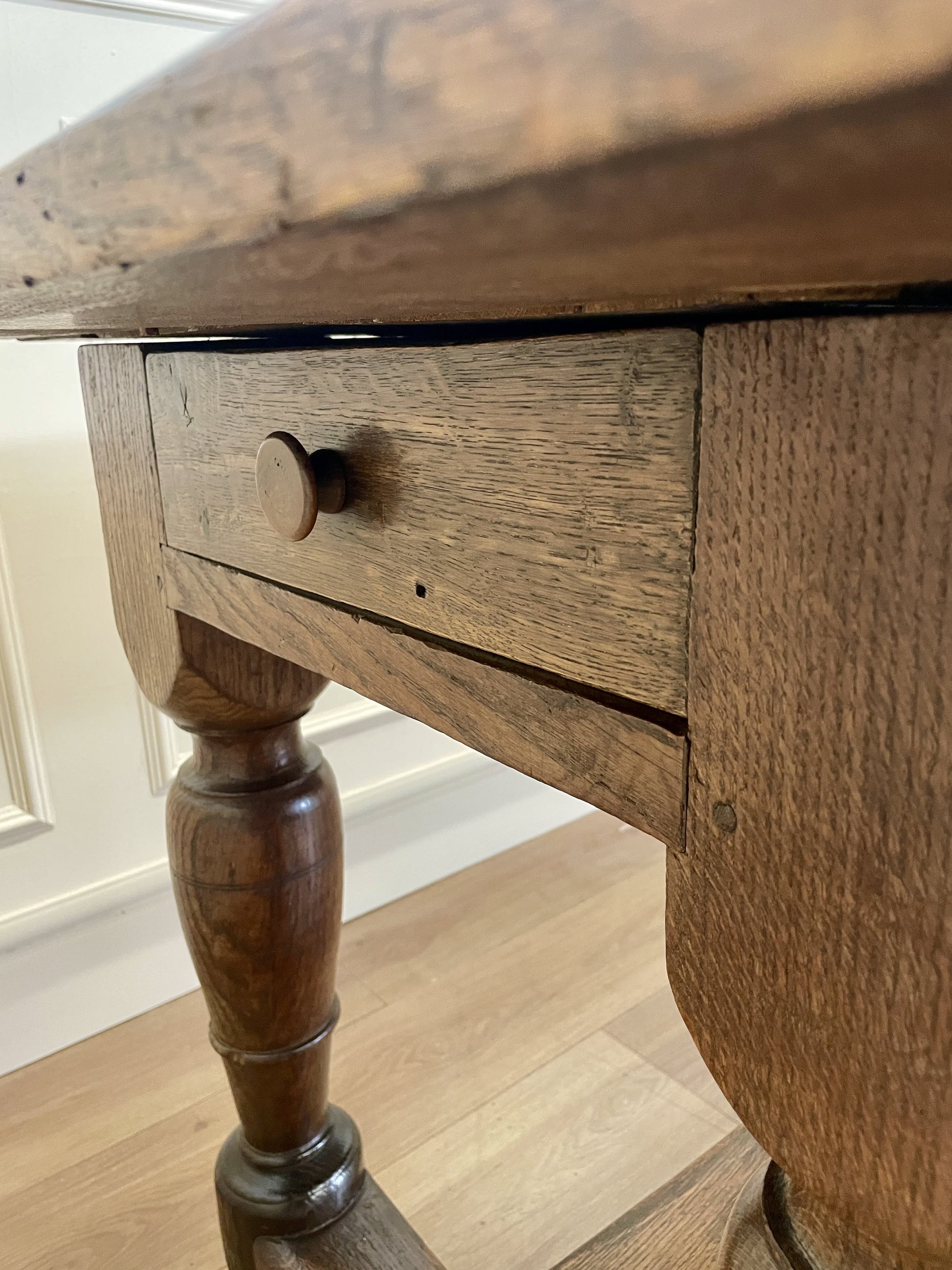 Wooden table with a drawer on a wooden floor