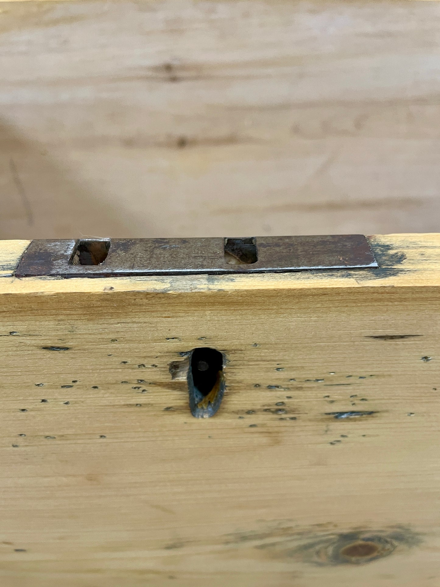 Wooden surface with a metal bracket attached