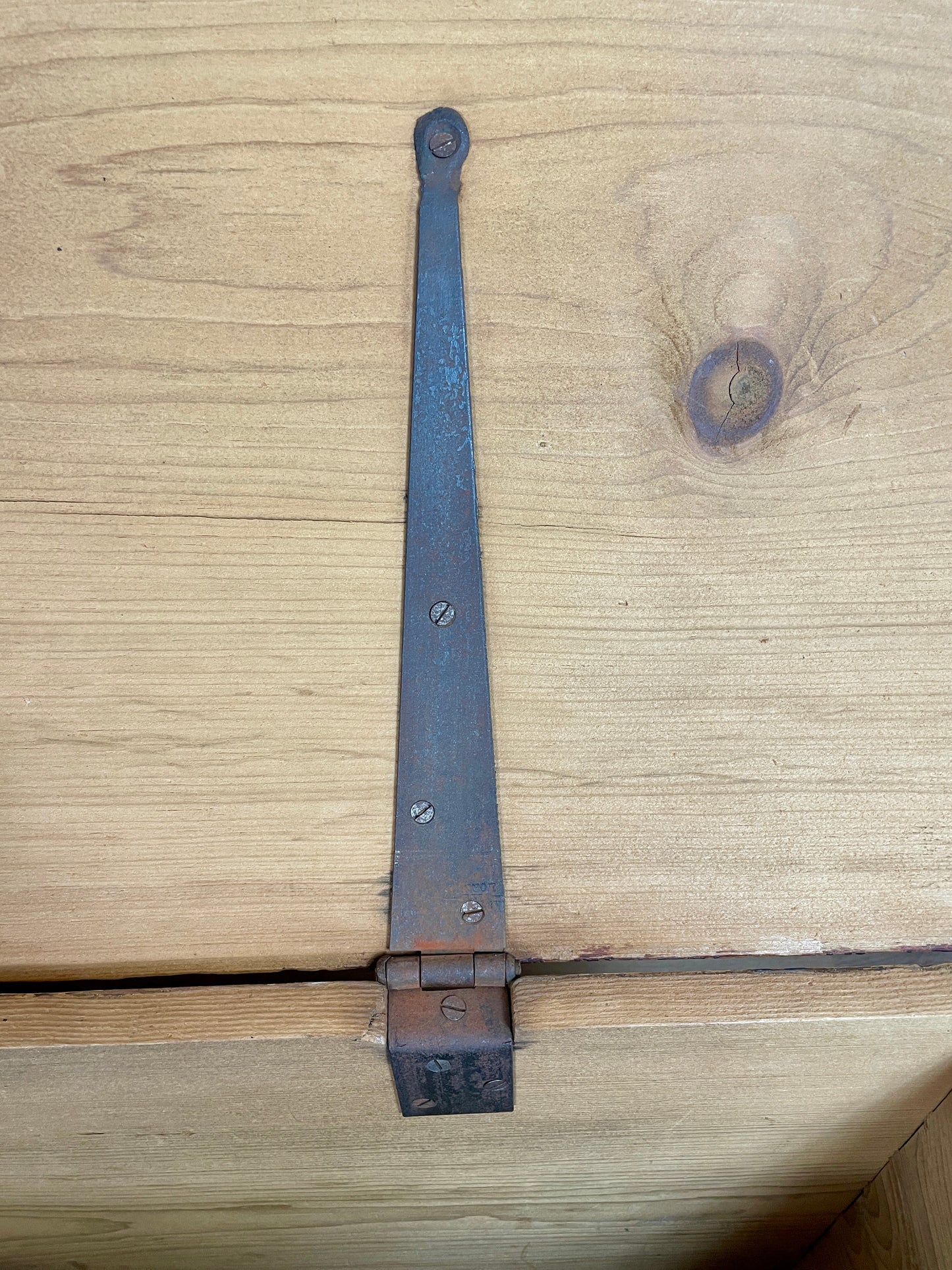 Metal hinge on a wooden surface
