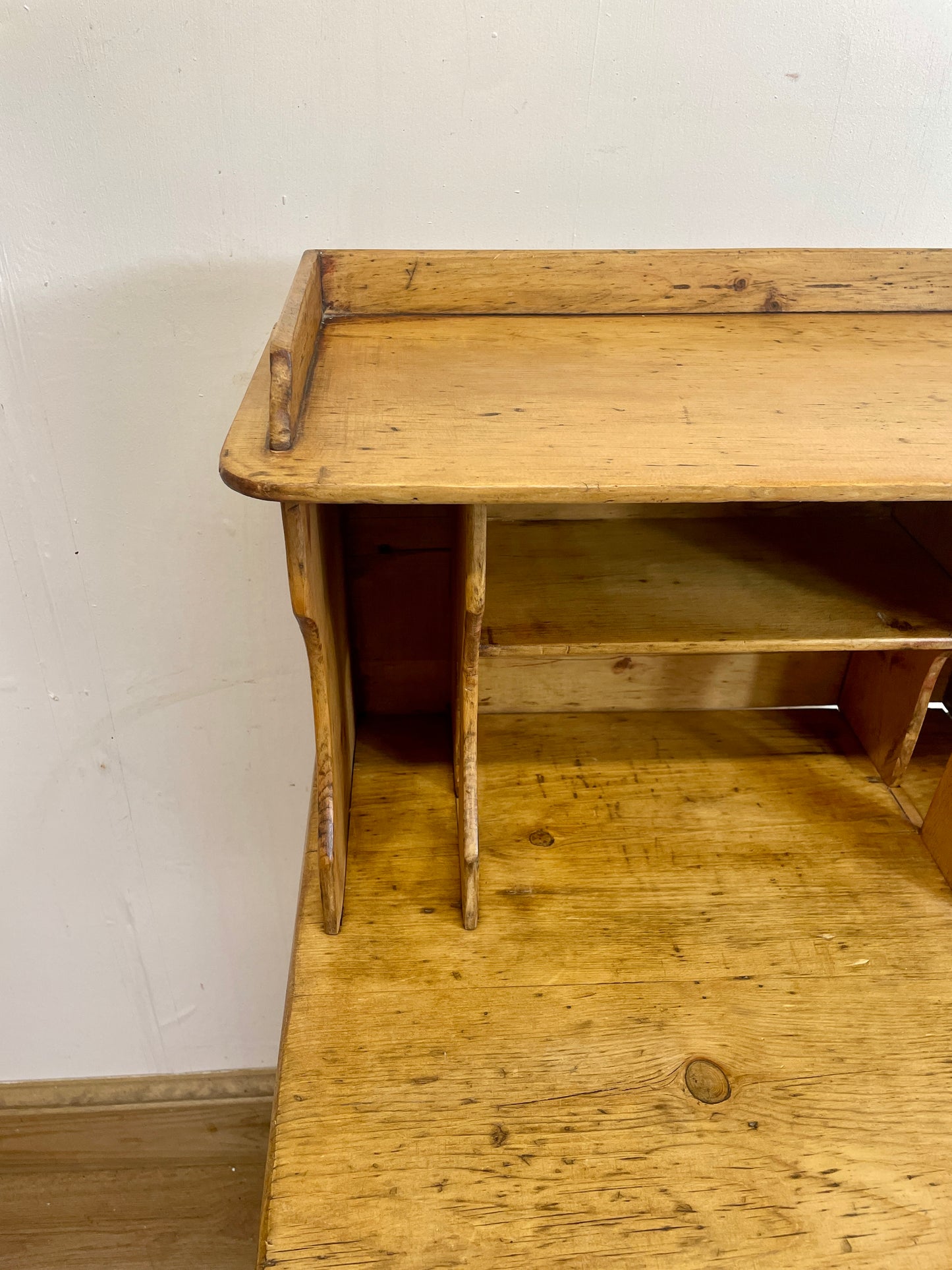 Wooden desk against a white wall