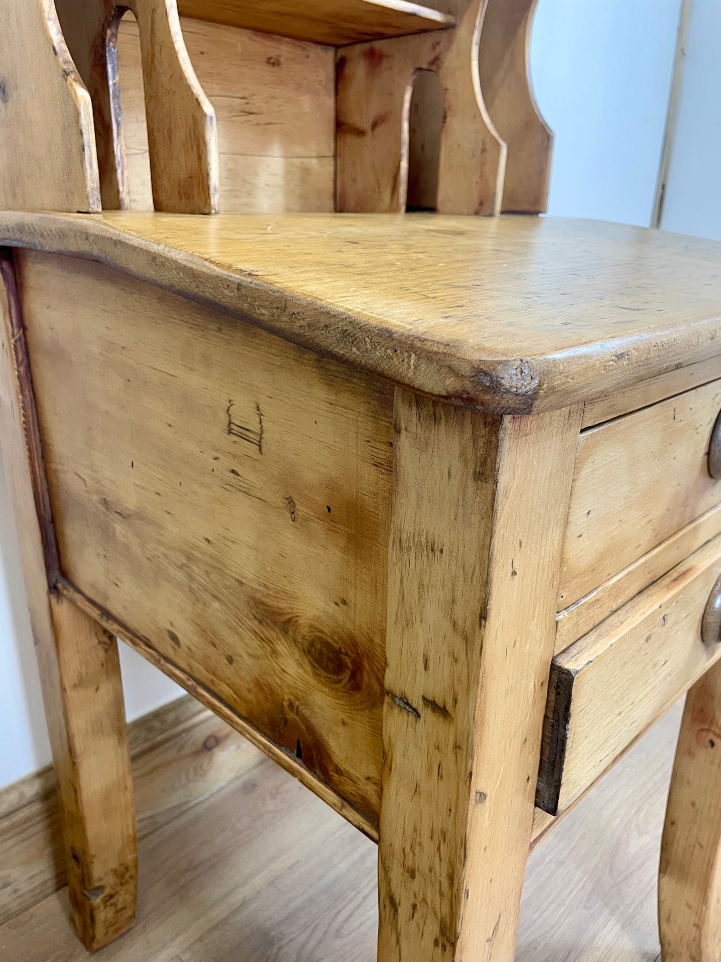 Wooden desk with a worn surface in a room setting