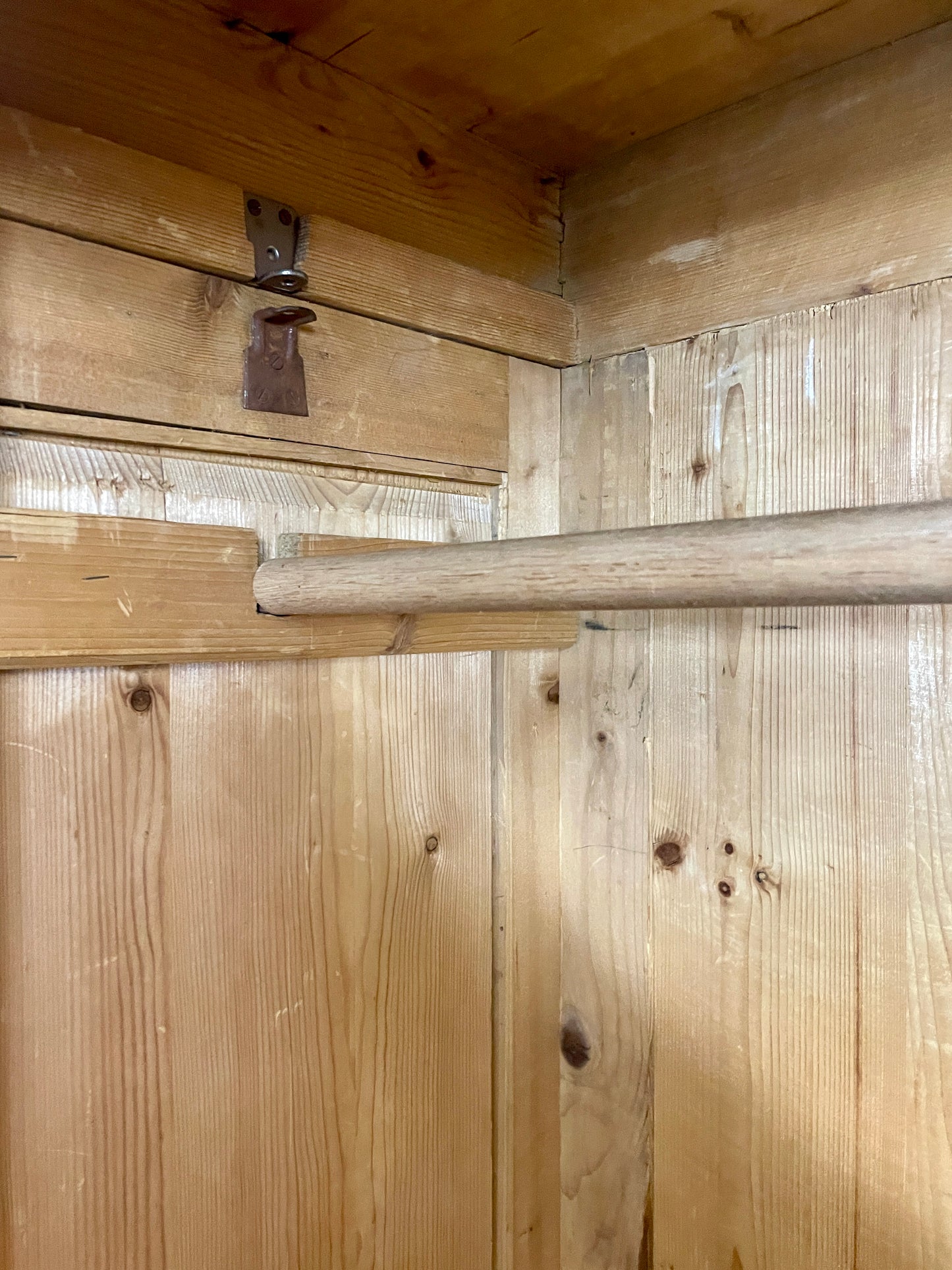 Wooden interior with a horizontal beam and a metal bracket.