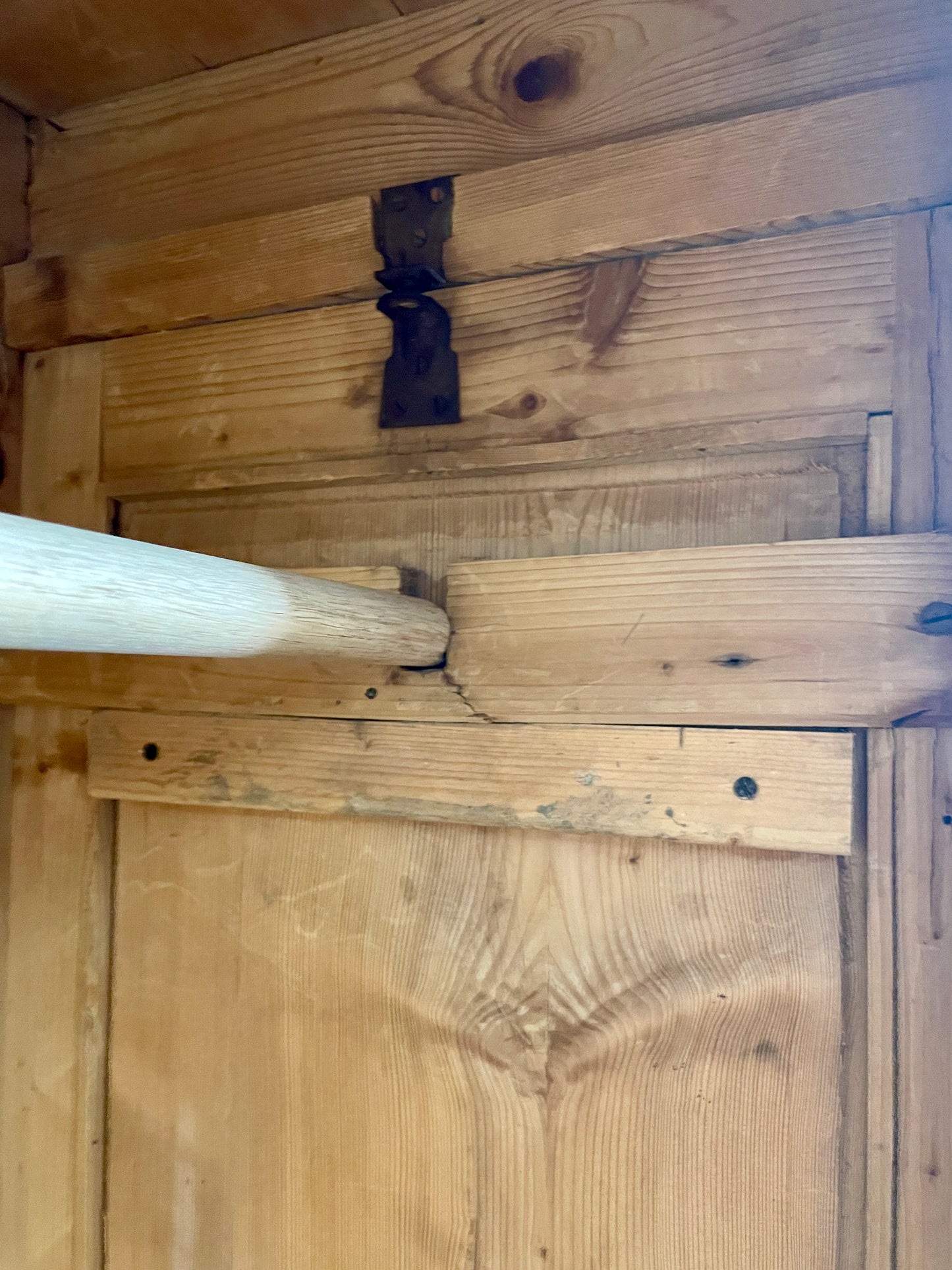 Close-up of wooden flooring with a metal bracket