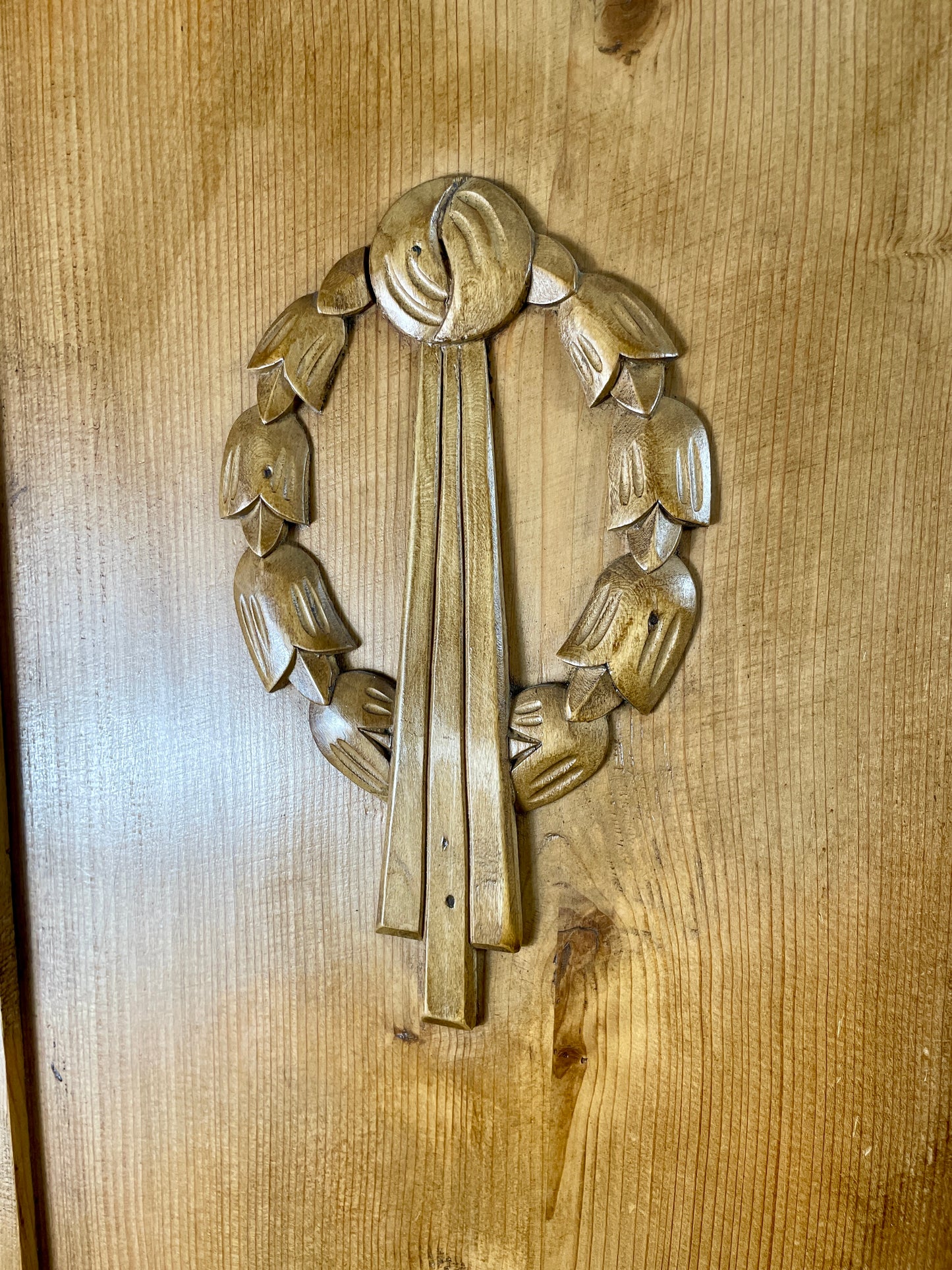 Decorative wooden panel with intricate carvings on a wooden surface
