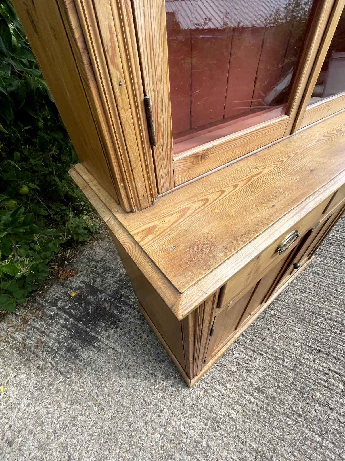 Wooden cabinet with glass door on a concrete surface