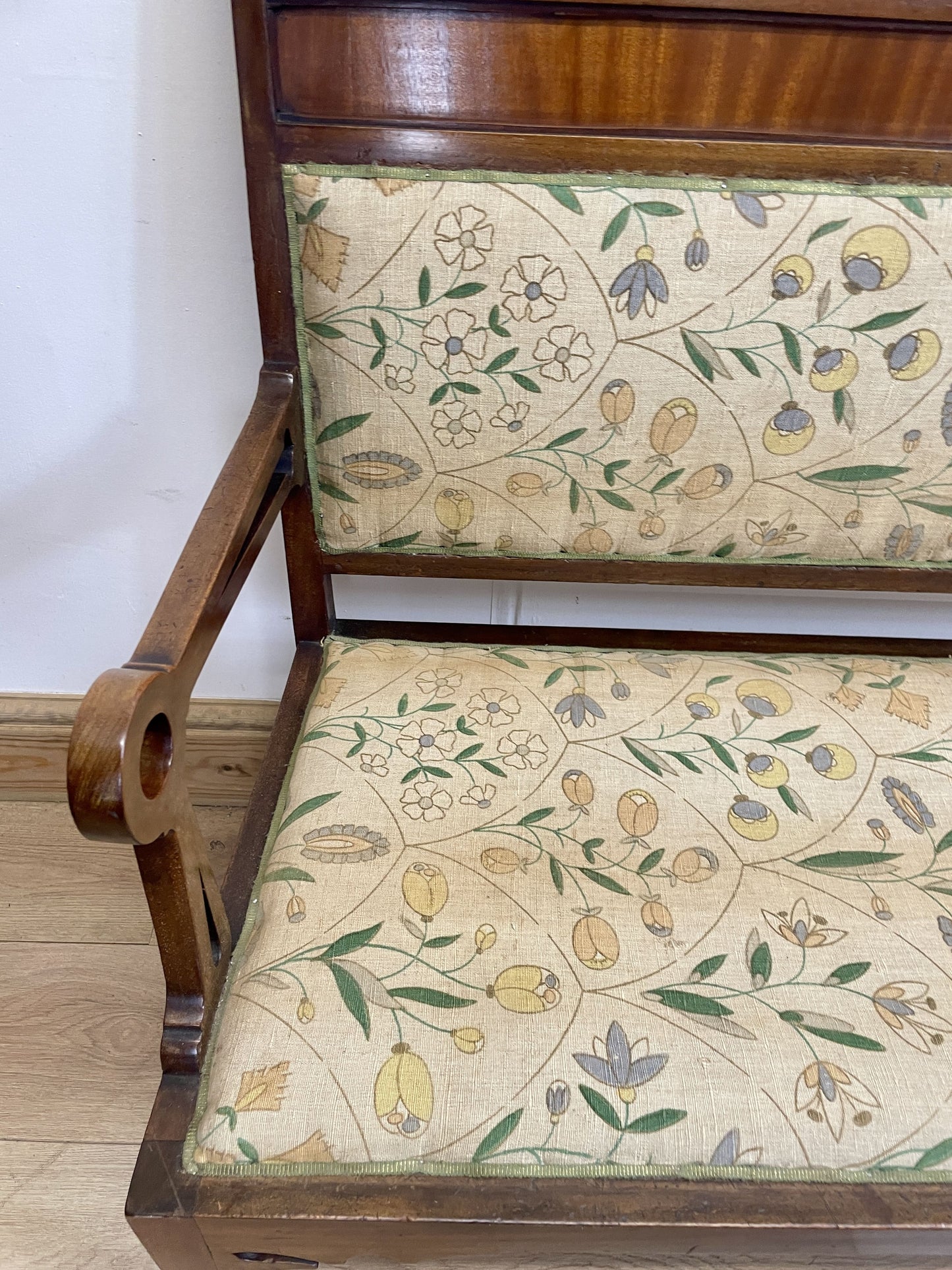 Wooden chair with floral-patterned fabric seat and backrest