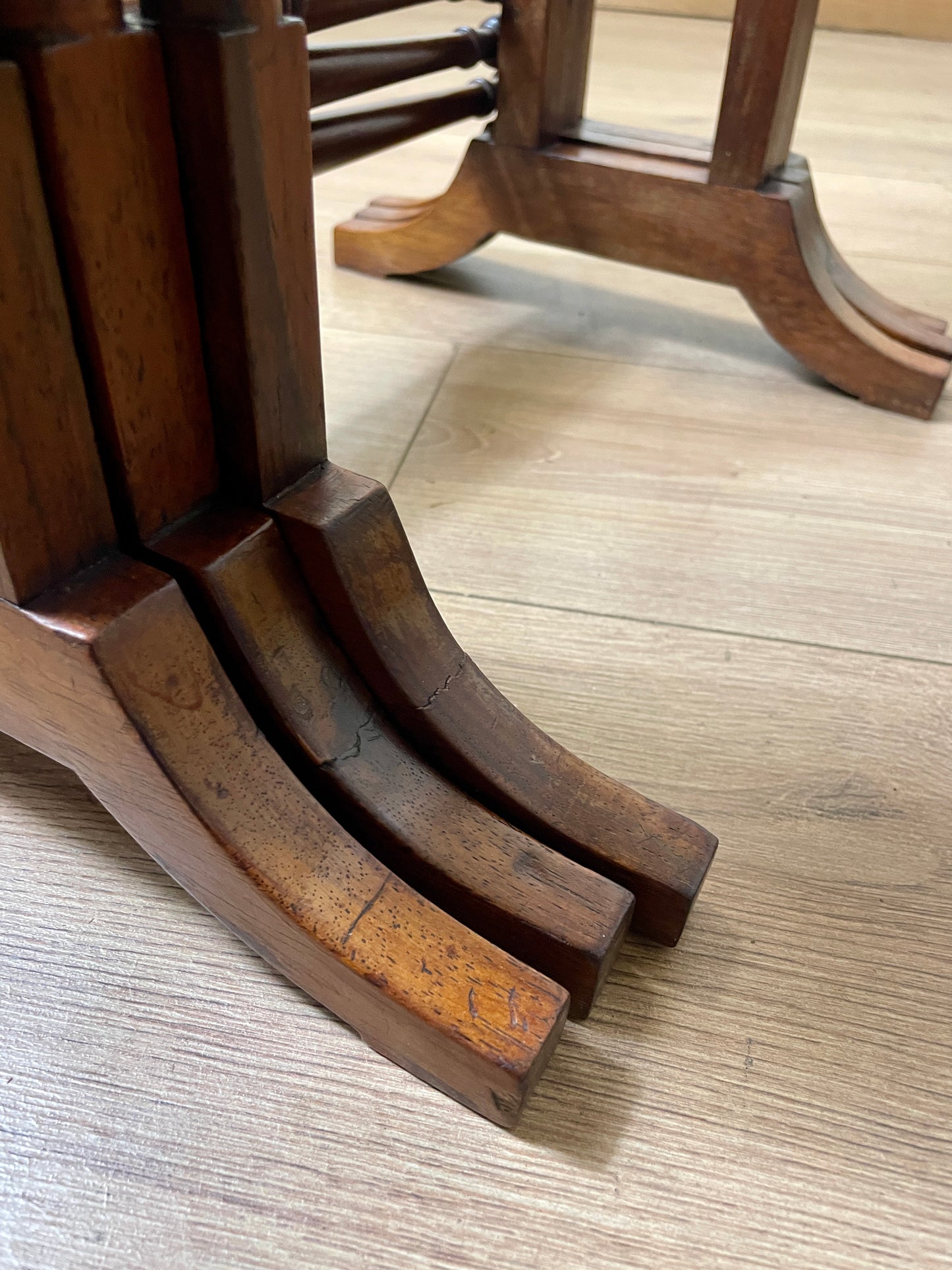 Close-up of wooden table legs on a wooden floor