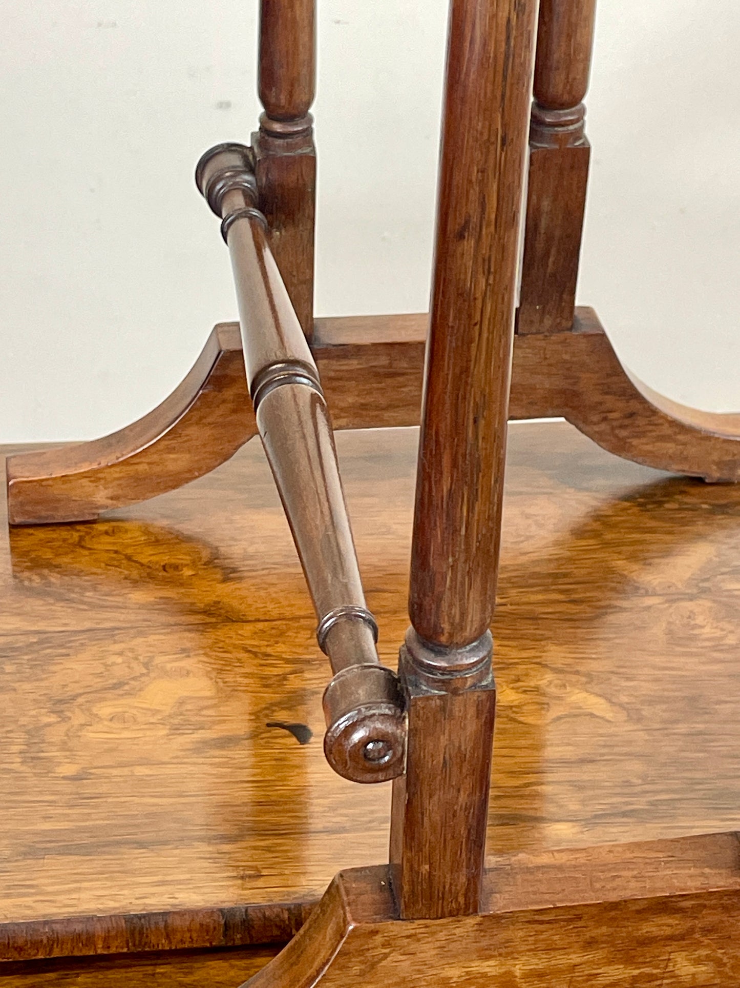 Close-up of a wooden chair with metal legs on a plain background
