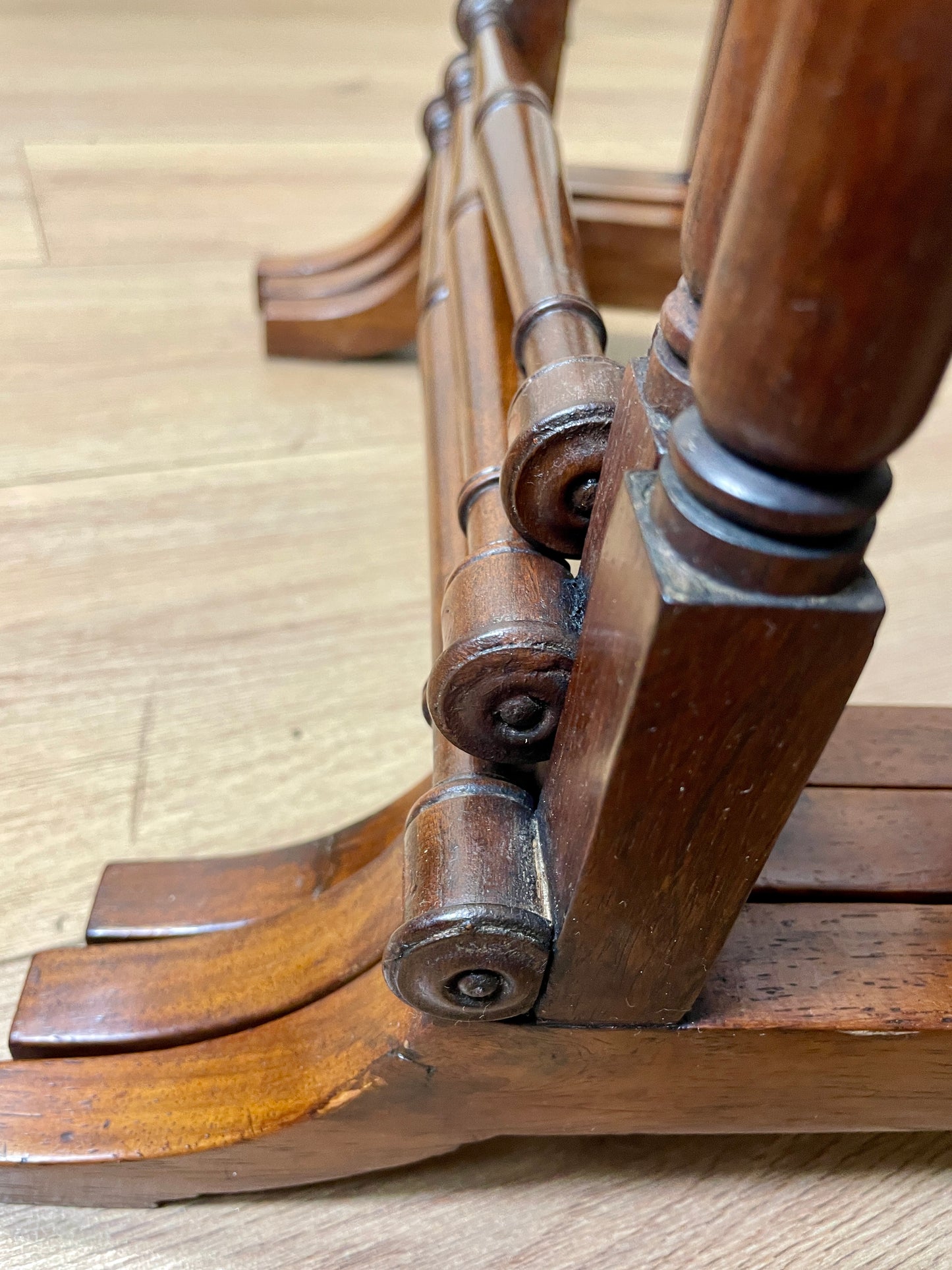 Close-up of wooden staircase balusters on a wooden floor.