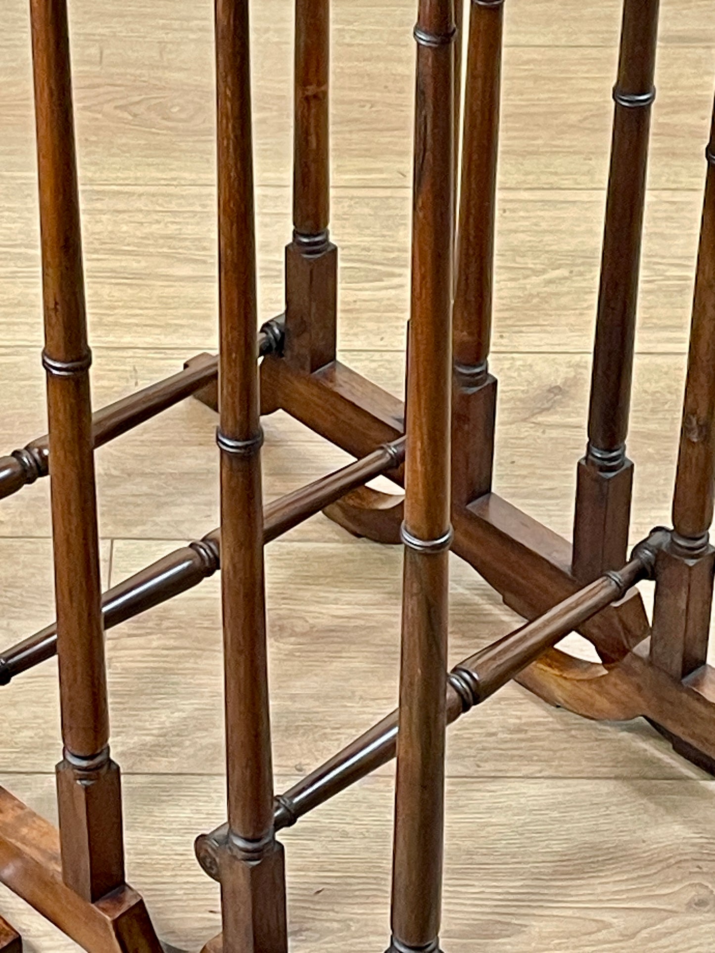 Wooden table with a bamboo-style design on a wooden floor.