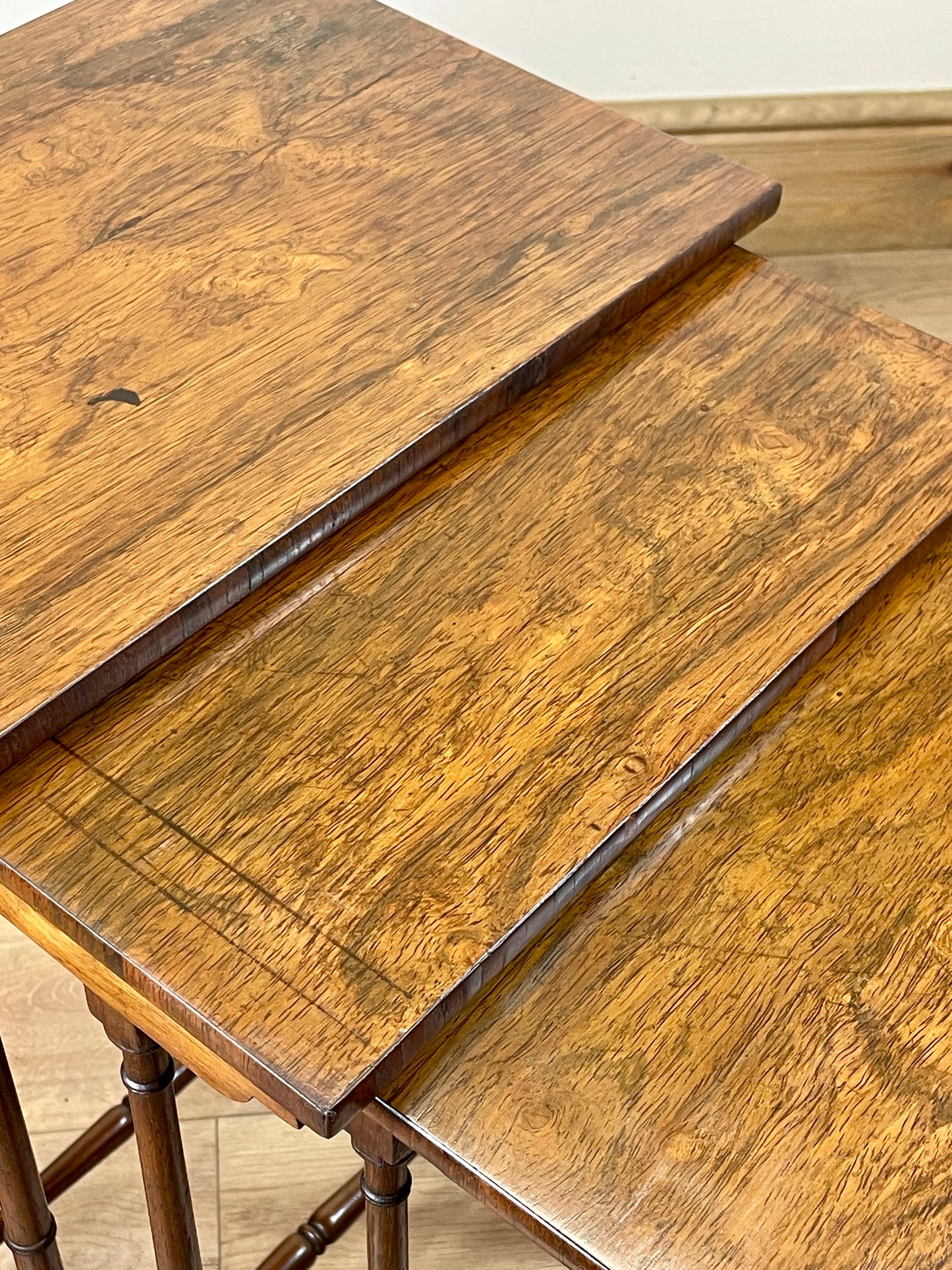 Two wooden nesting tables with a light wood finish.