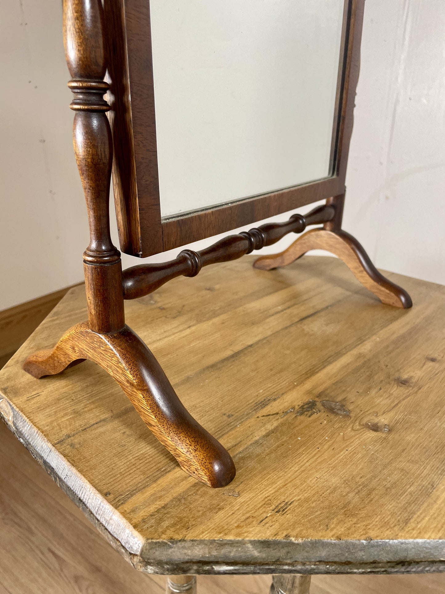 Wooden stand with a mirror on a wooden surface