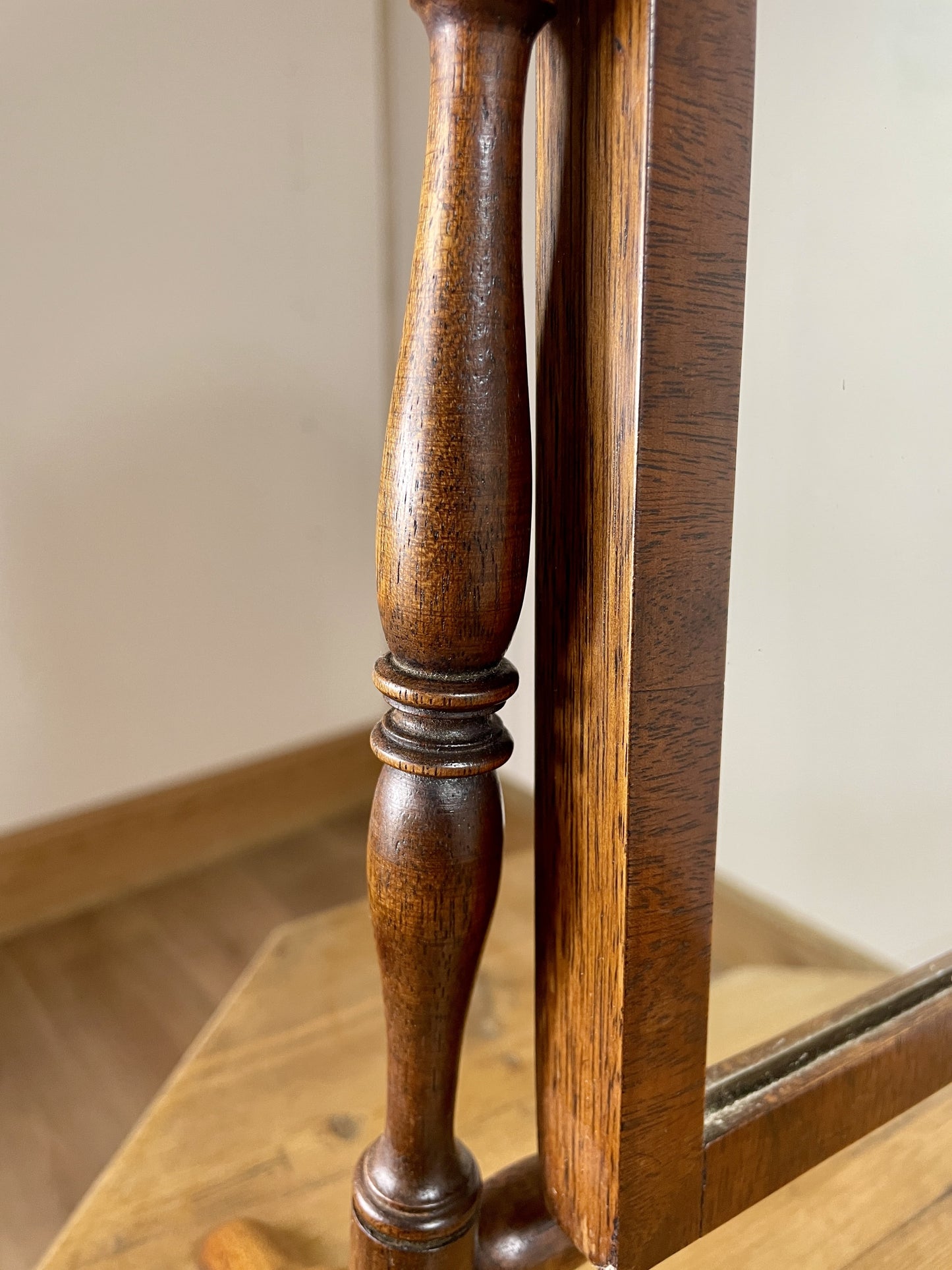 Close-up of a wooden mirror with a decorative frame.