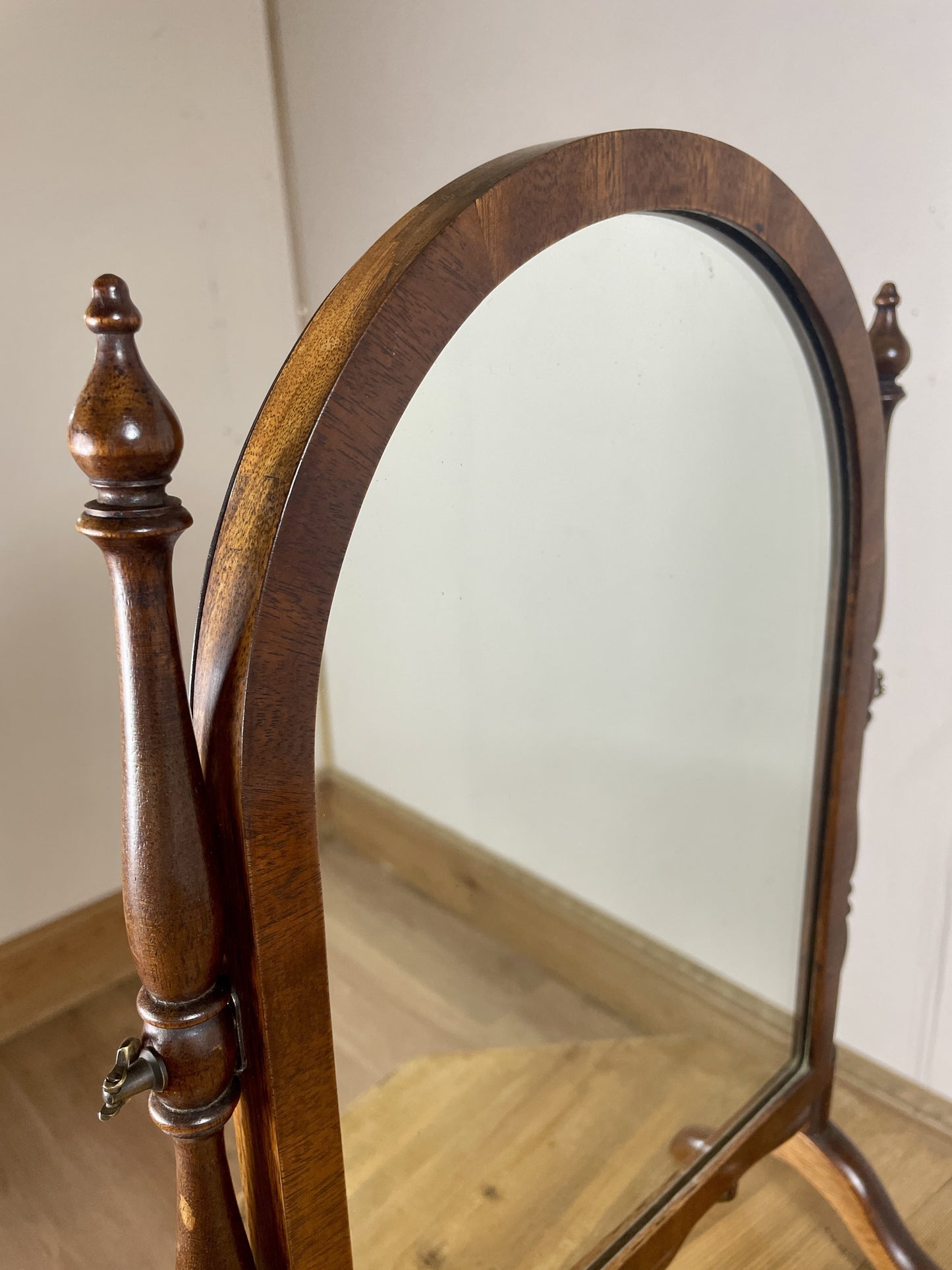 Wooden cheval mirror with a plain background