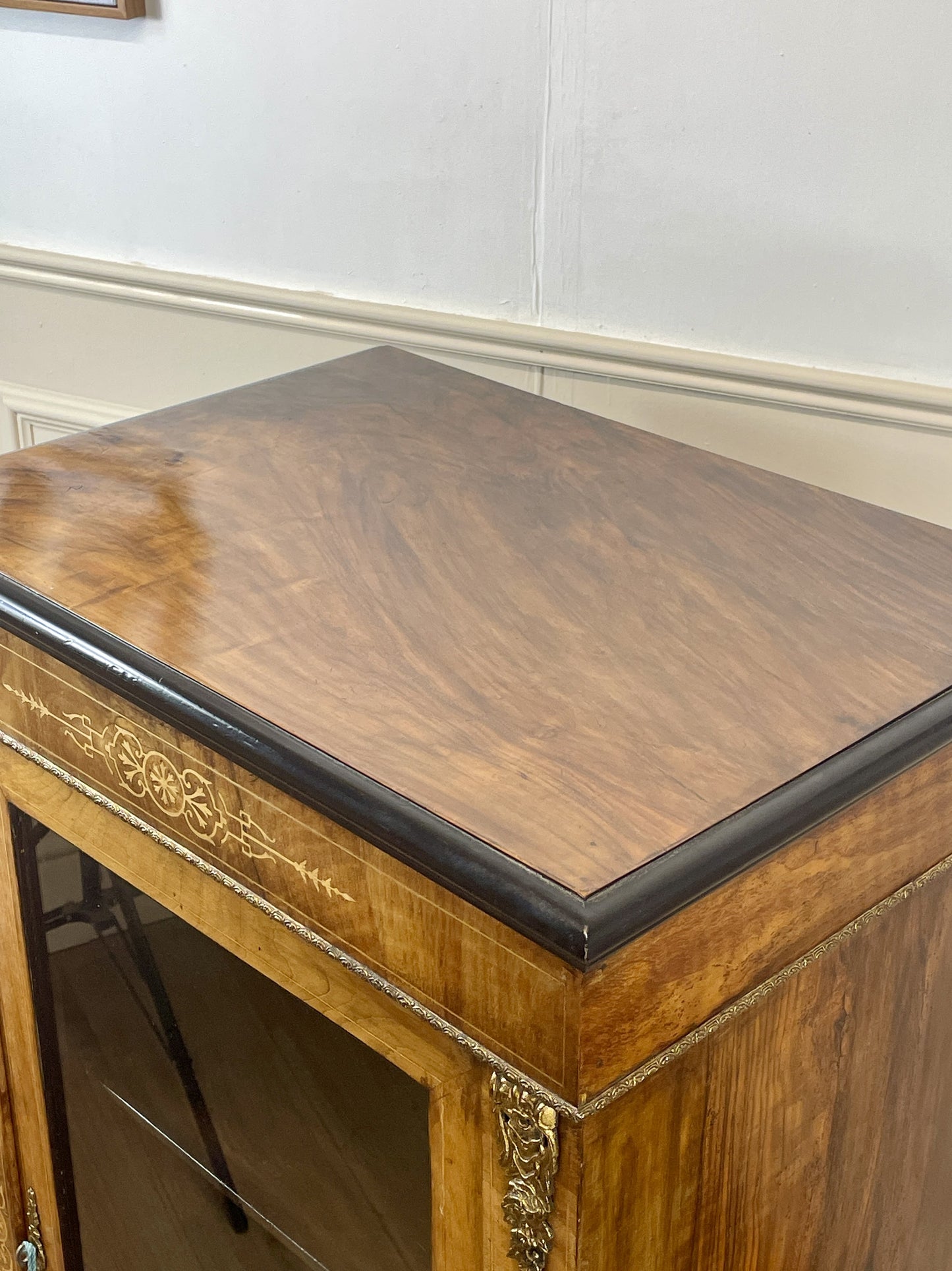 Wooden side table with decorative carvings on a plain background