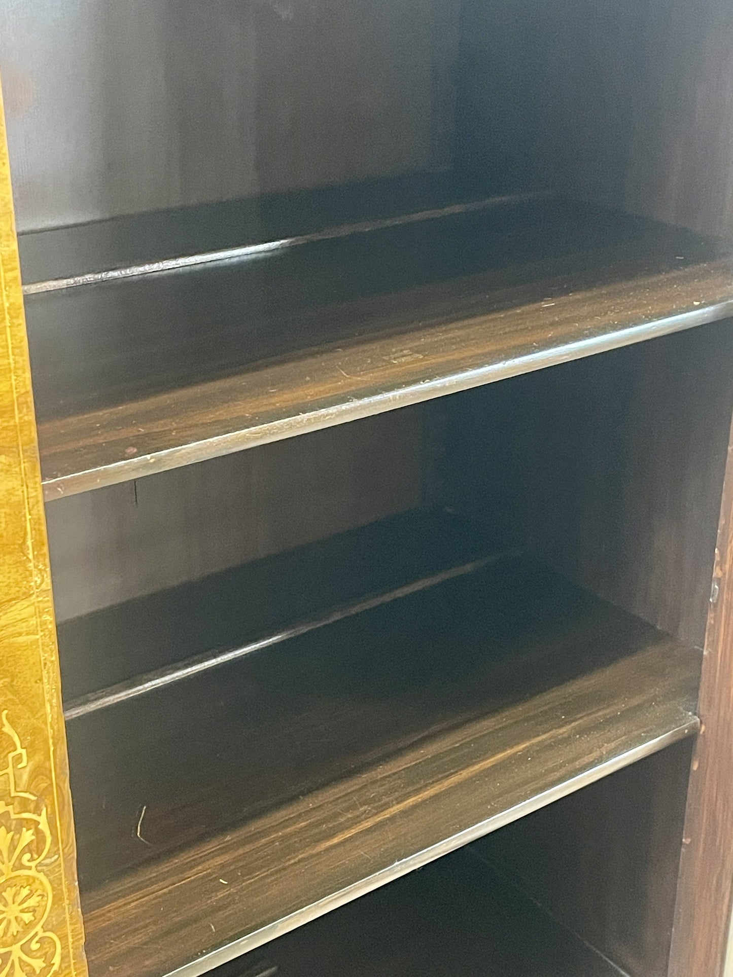 Wooden bookshelf with three shelves in a dark brown color.