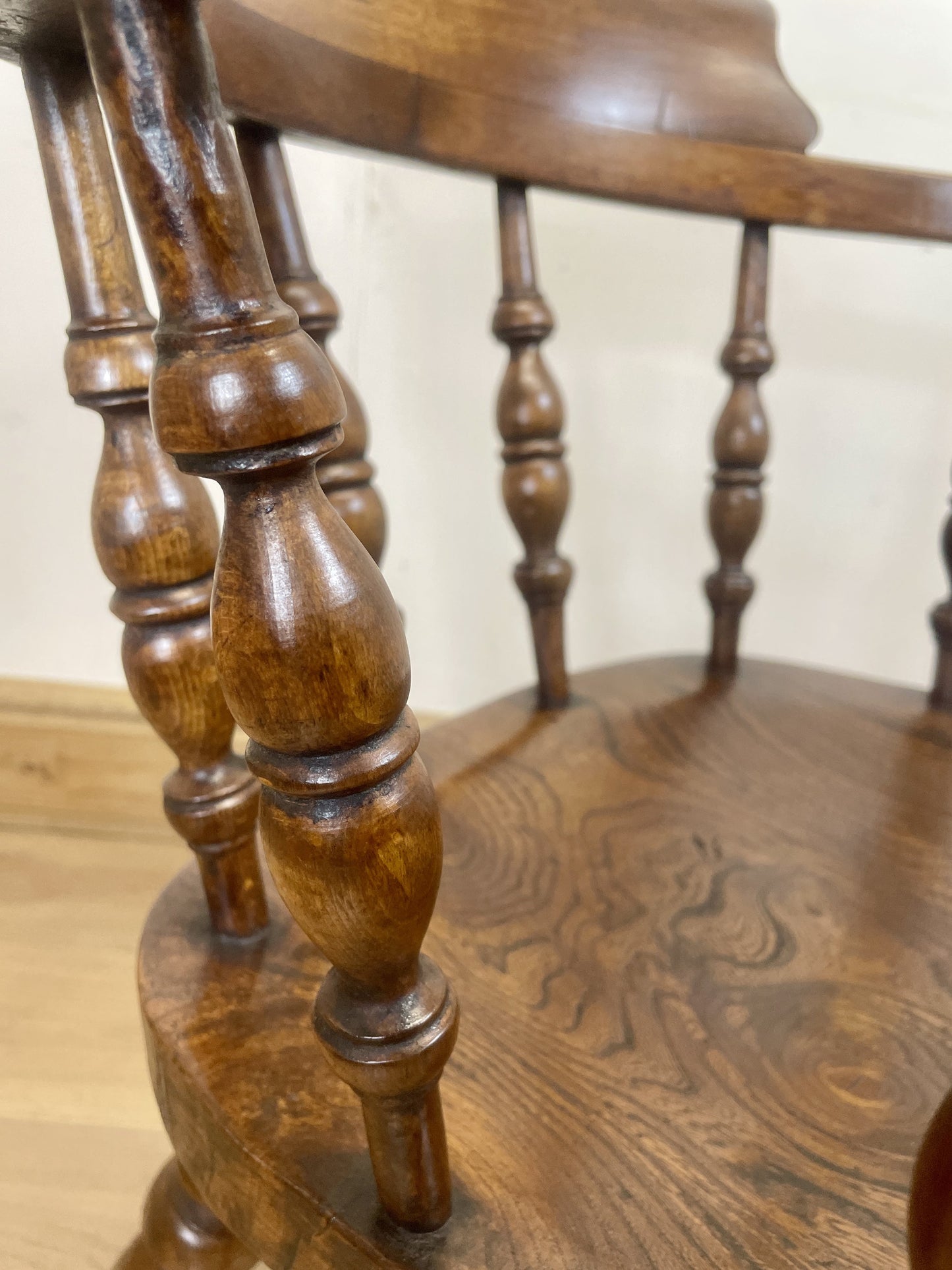 Close-up of a wooden chair with intricate carvings on a light background