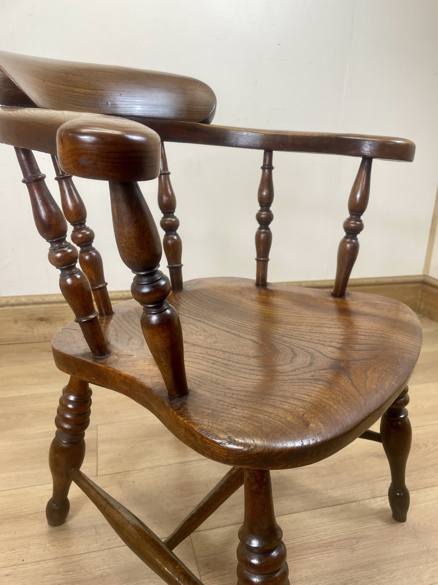 Wooden chair with spindle back on a wooden floor