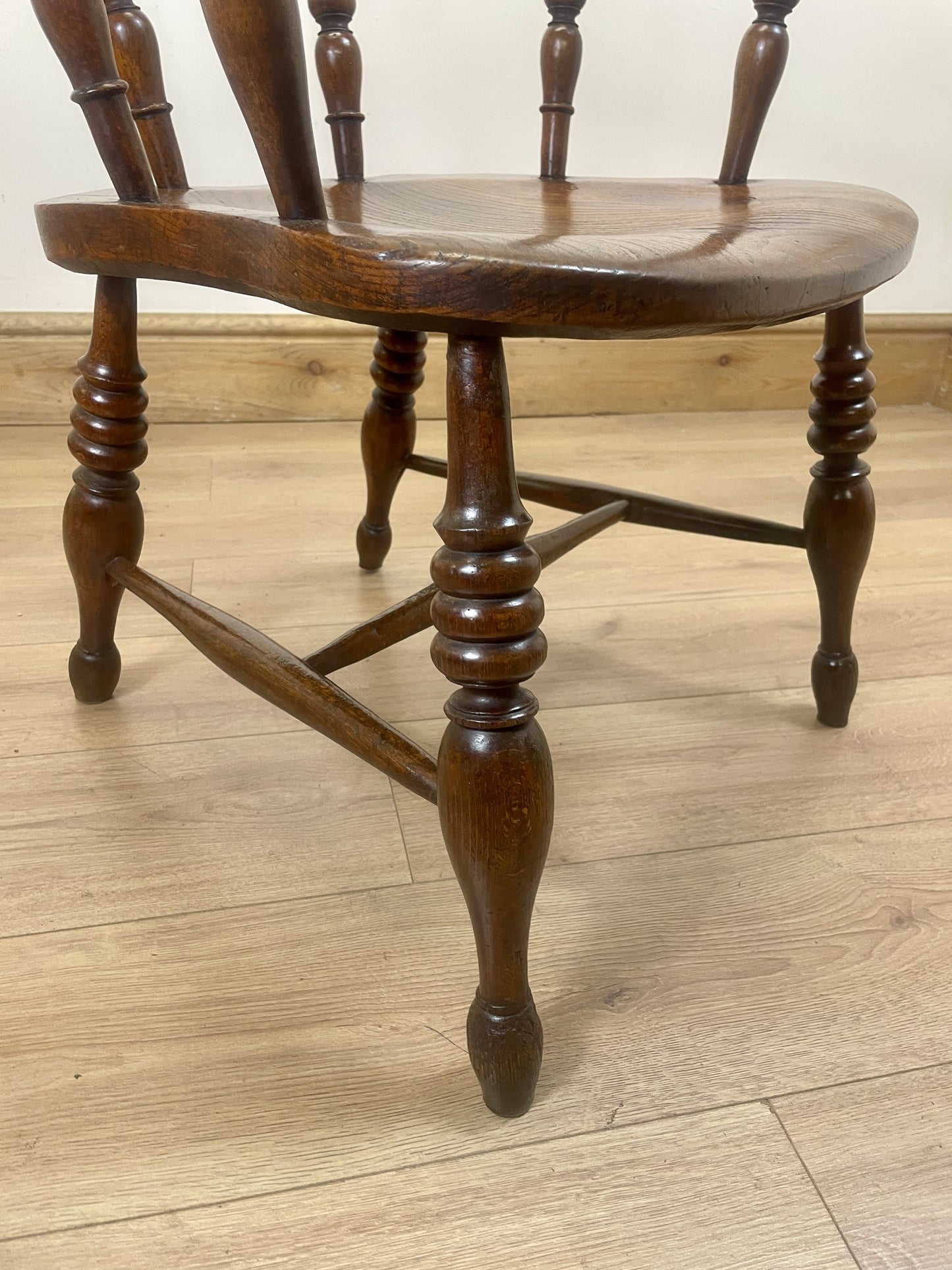 Wooden chair with spindle back on a wooden floor