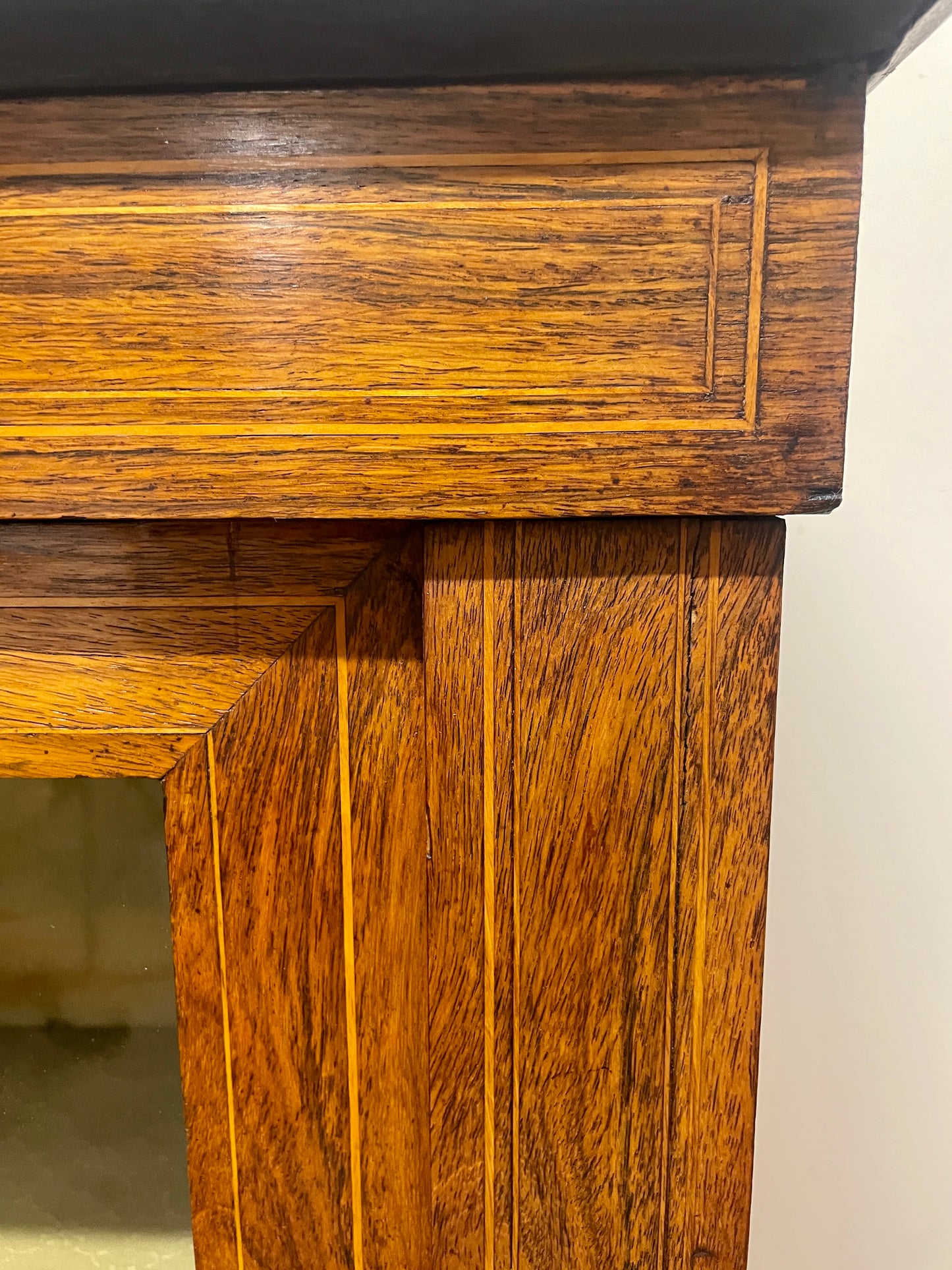 Close-up of a wooden desk corner with visible grain and texture.